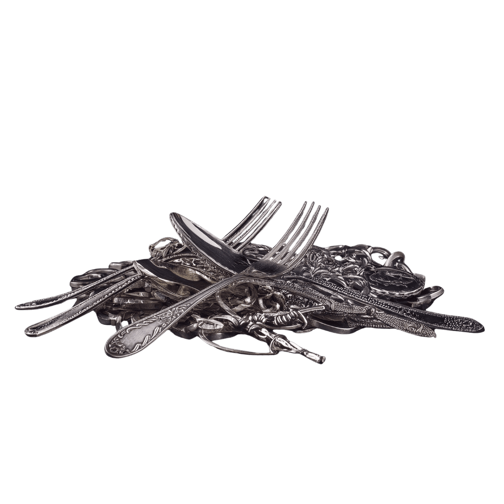 Large pile of sterling silver forks and spoons representing bulk estate liquidation services.