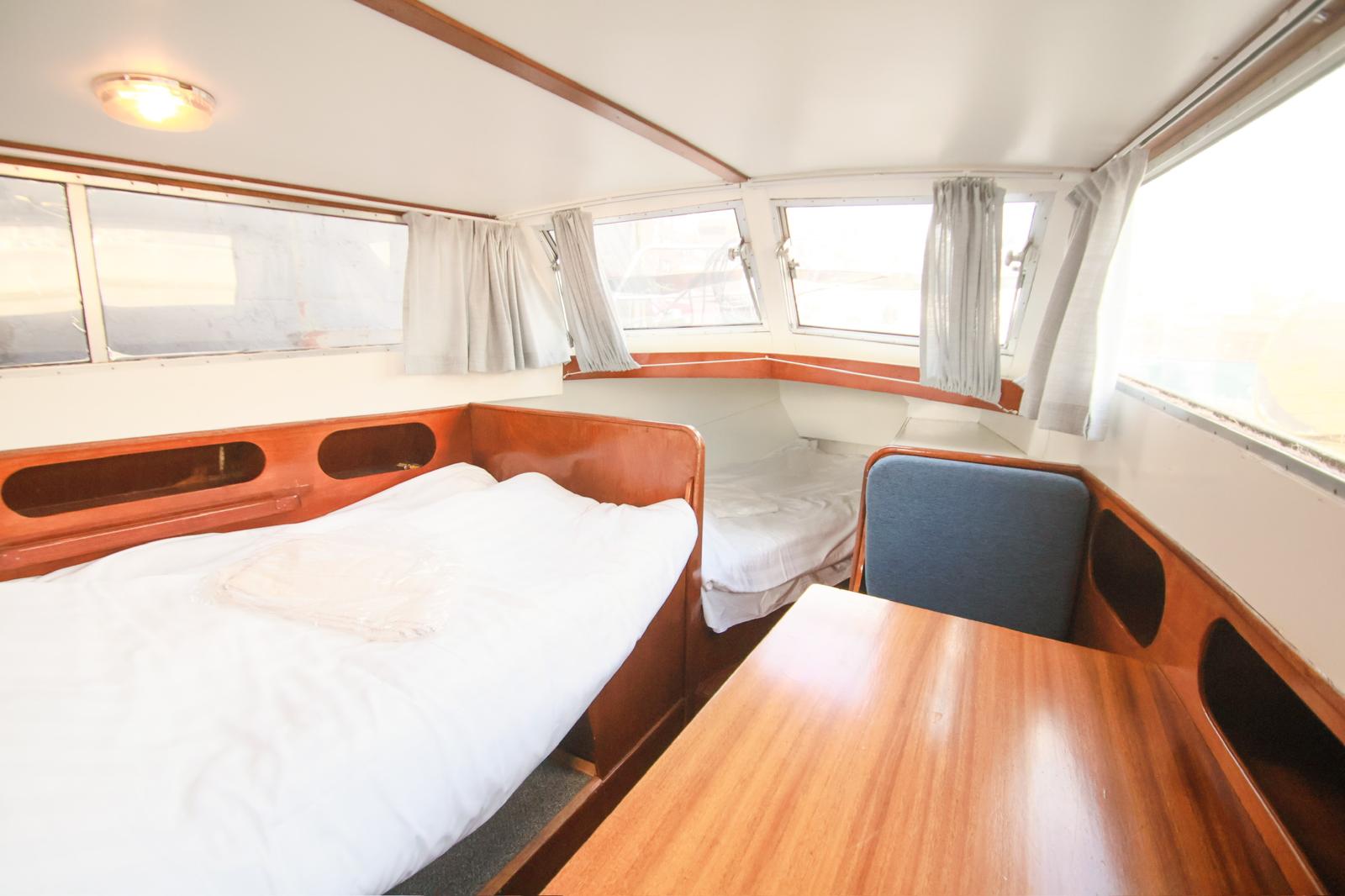 Grey marble bathroom with round mirror and floating sink