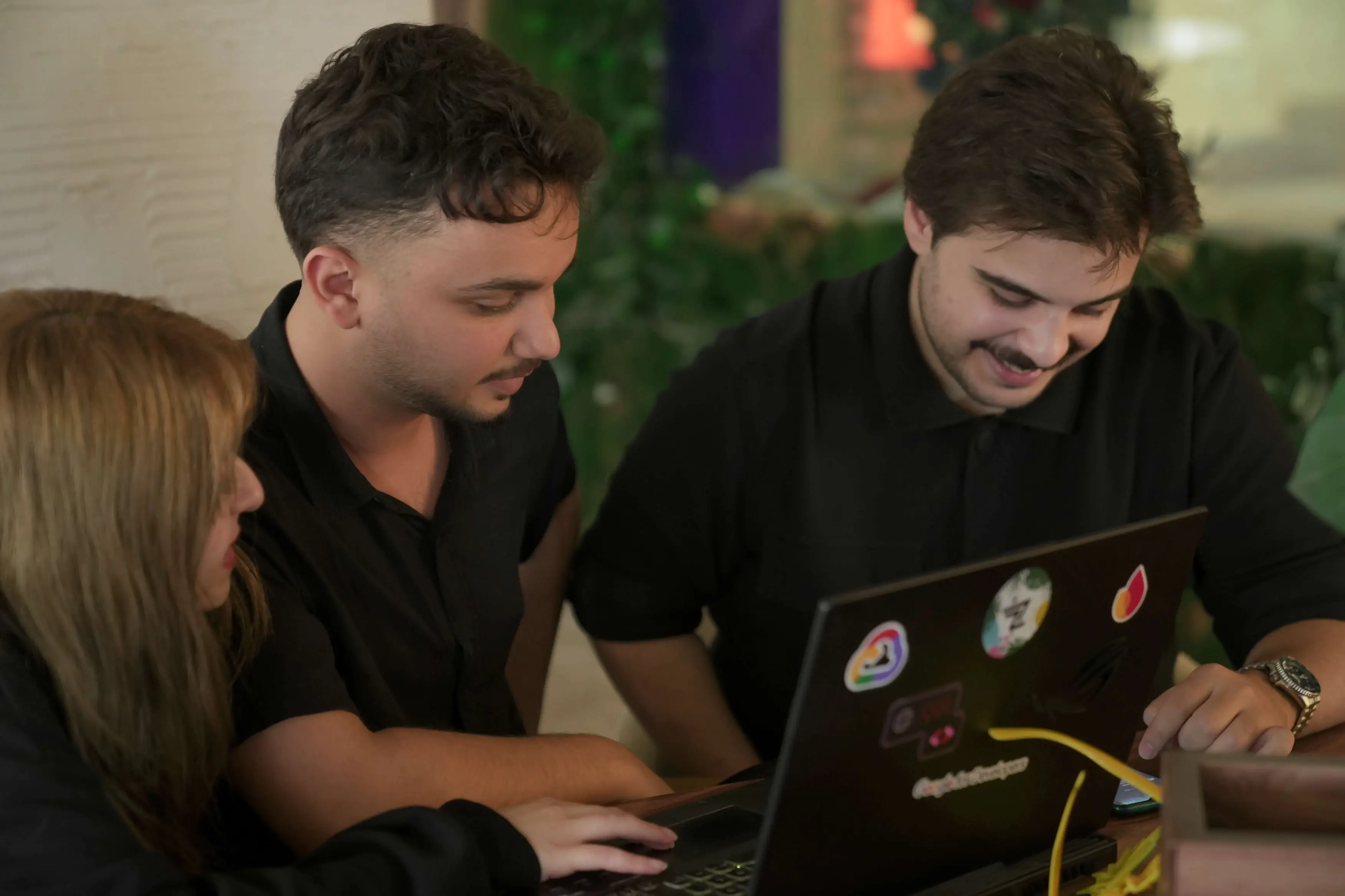 Neon Apps team members reviewing work together, symbolizing growth and continuous improvement.