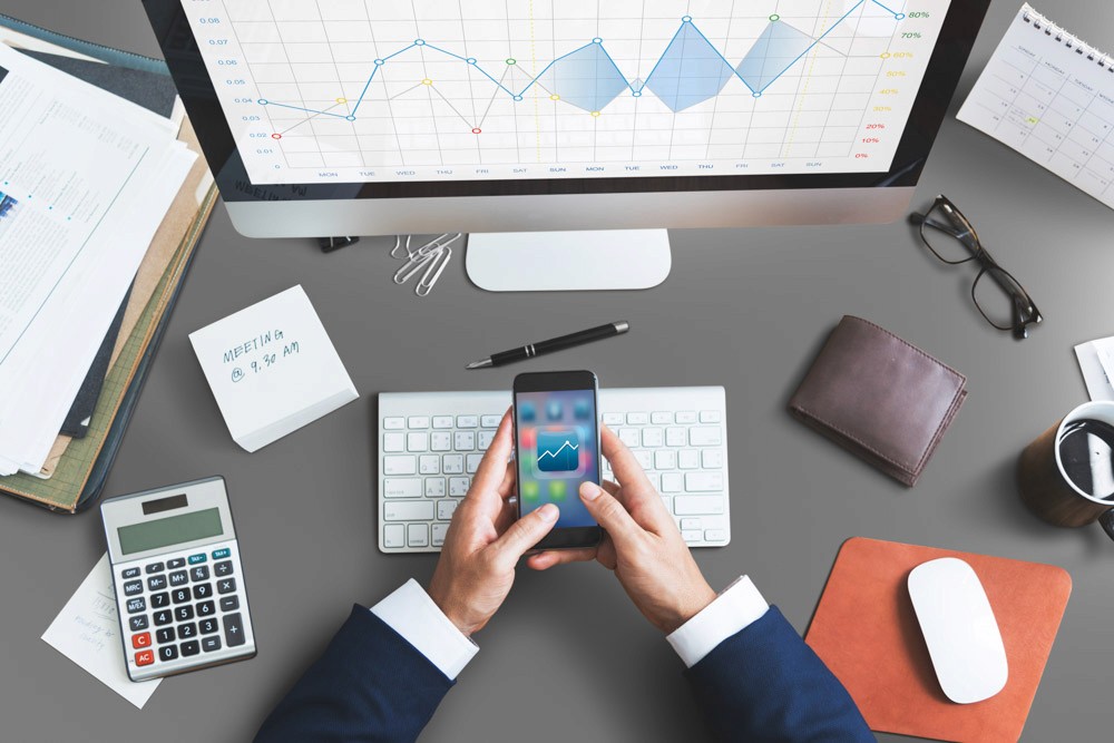 woman in brown coat using macbook air