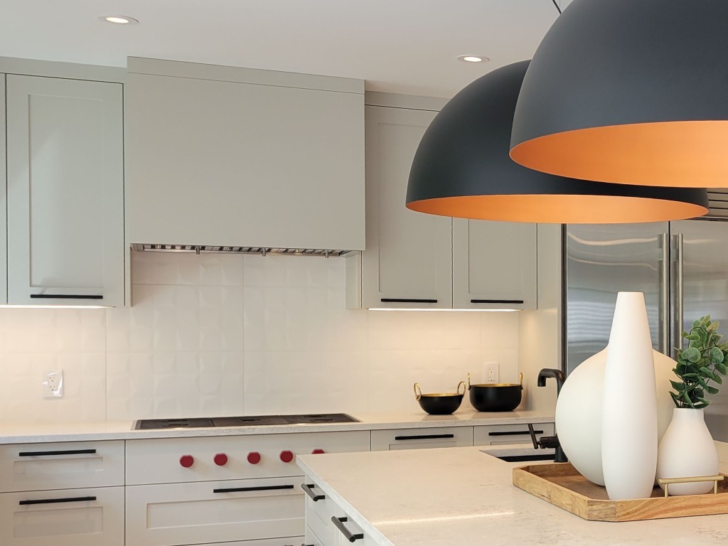 Image of Modern kitchen design with gray cabinets, white countertops, and pendant lighting by KHD Homes.