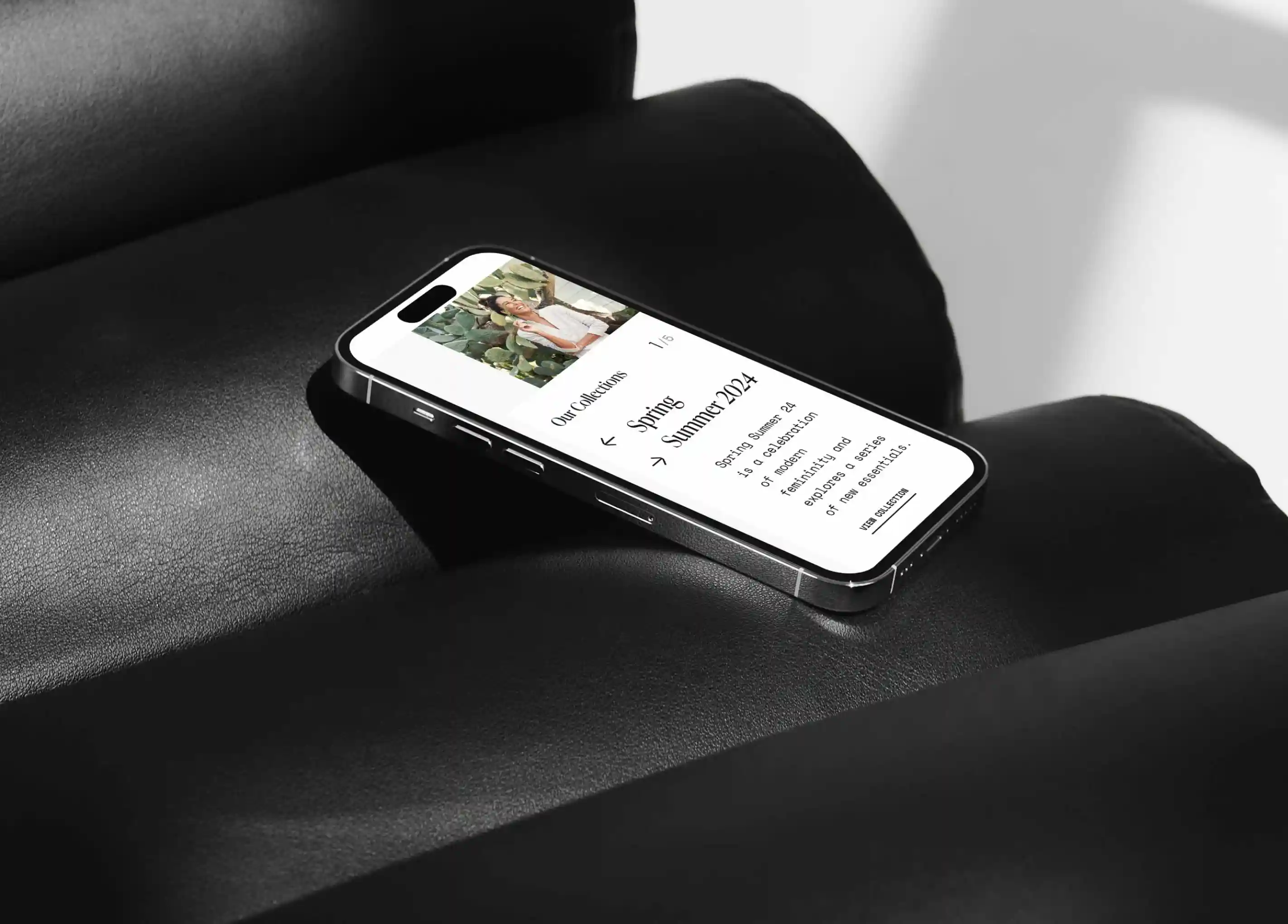 Phone laid down on couch with Garbarini website opened.