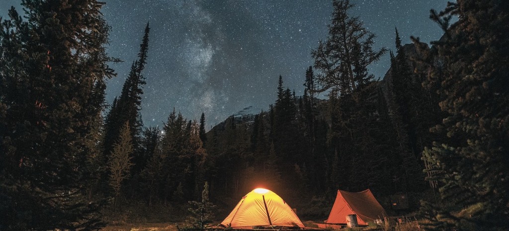 Camping outdoors under starry sky