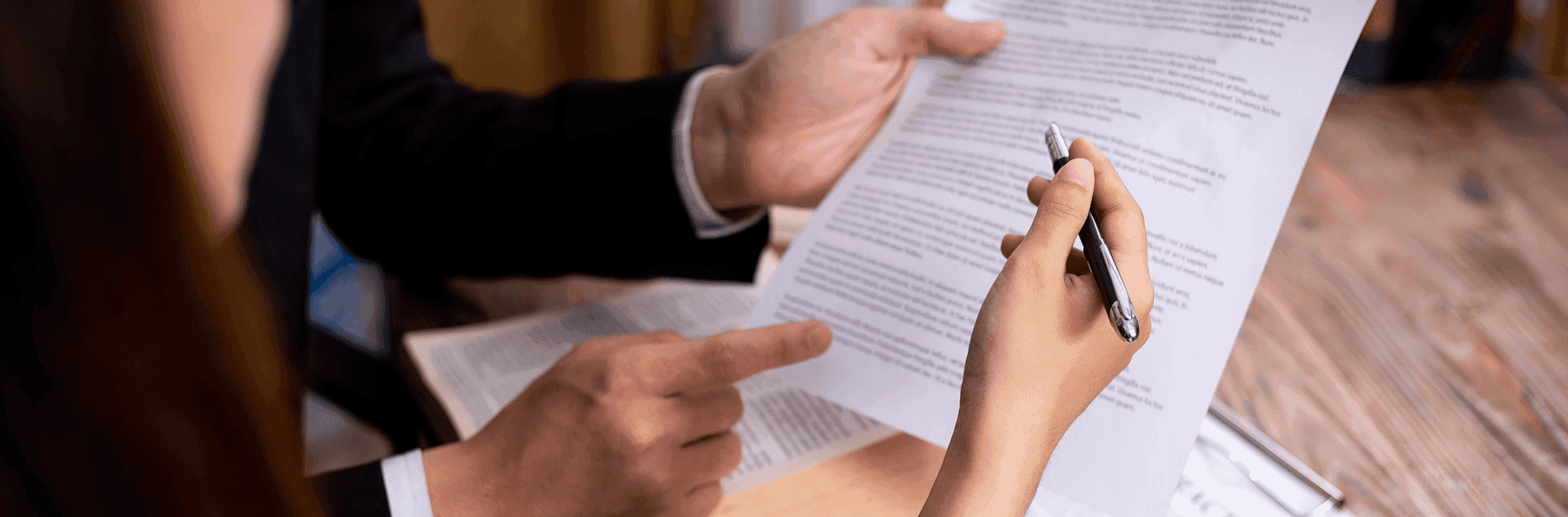 Two people discussing a document - Best Software For Automating Document Templates