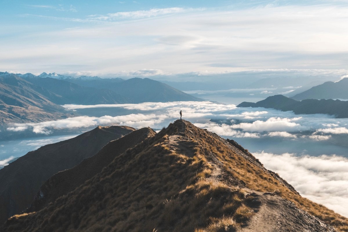 three brown wooden boat on blue lake water taken at daytime