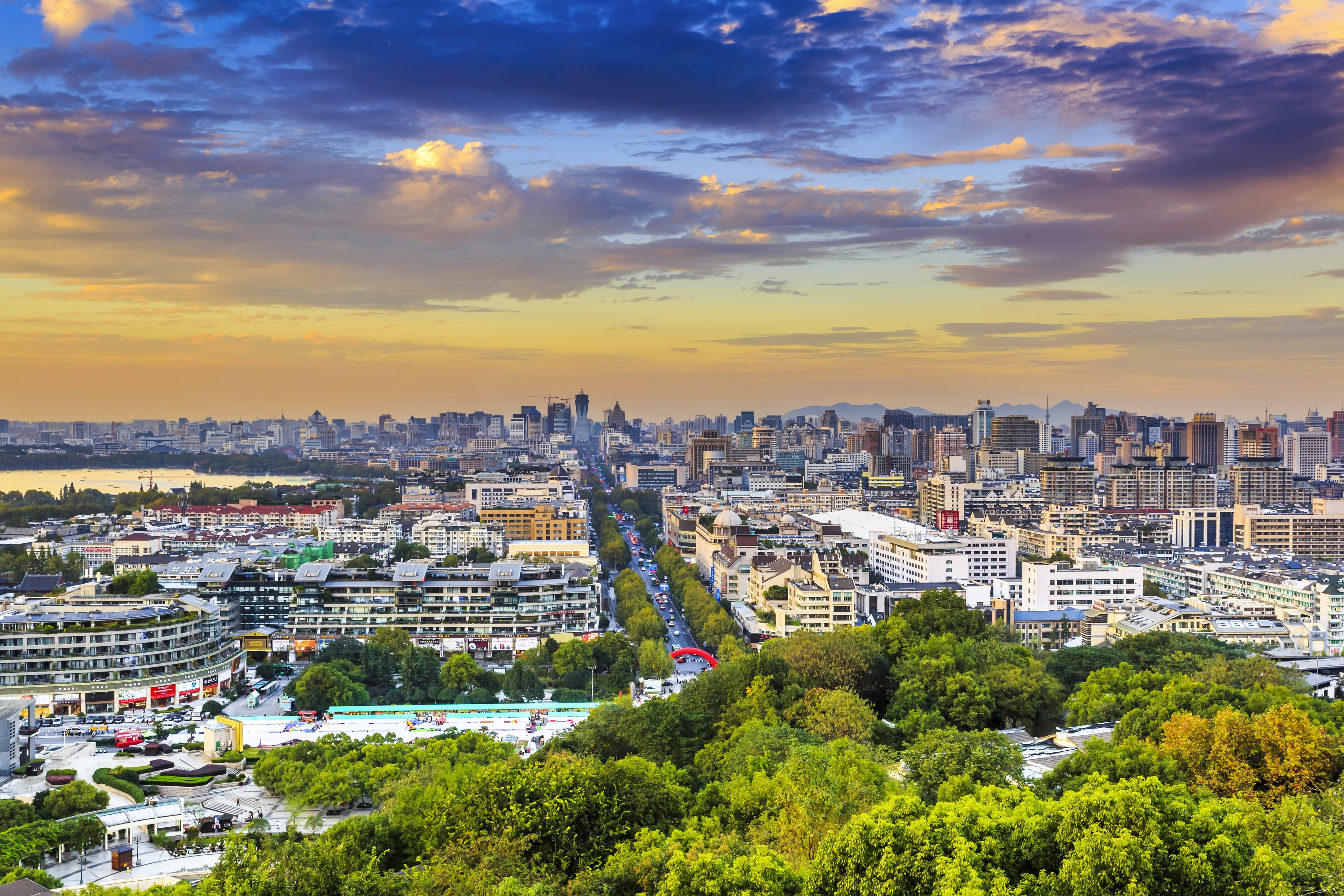 red train travelling near body of water
