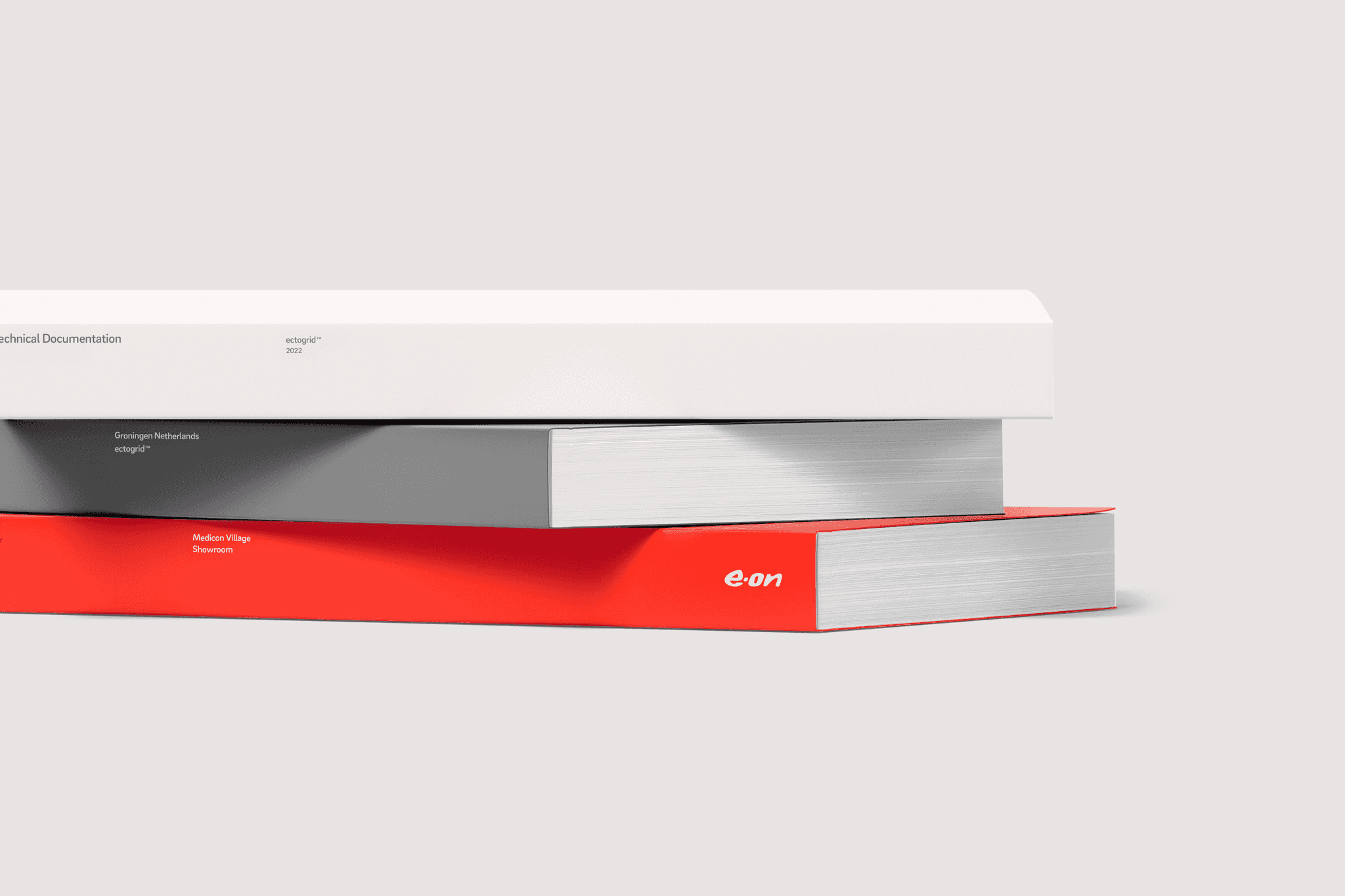 Stack of three books - white, grey, red