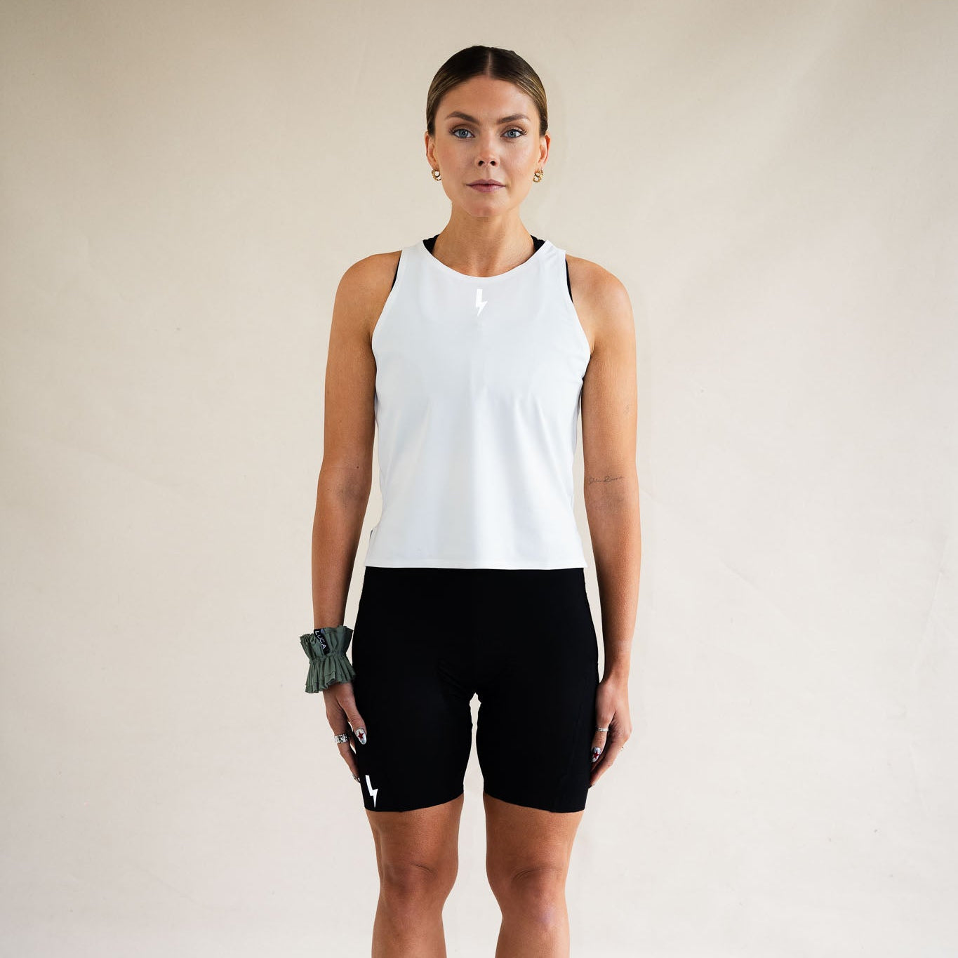 Cyclist wearing LUCA Meander vest in white with cycling shorts, front view