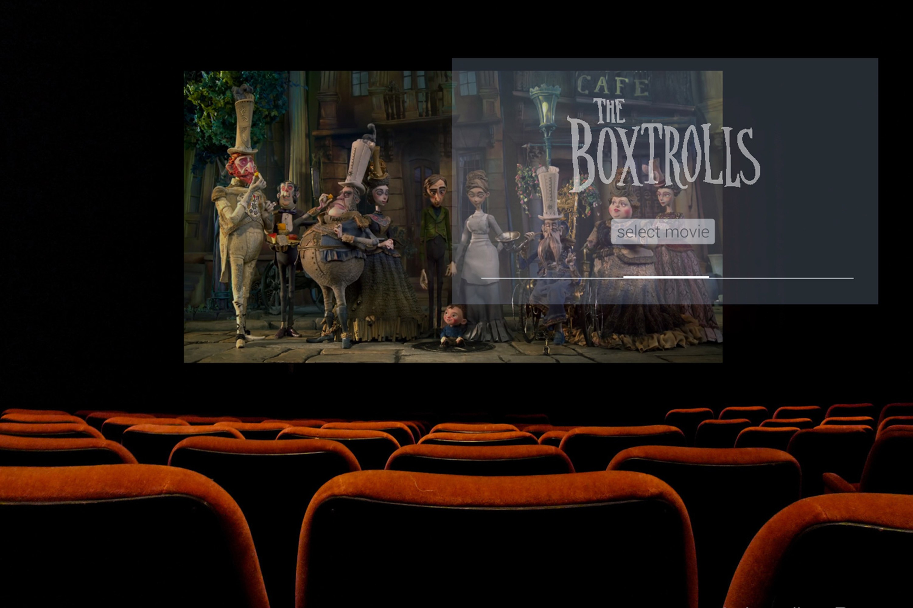 A person's point of view seated in middle of a movie theater with a Google Glass UI screen superimposed on a movie screen.