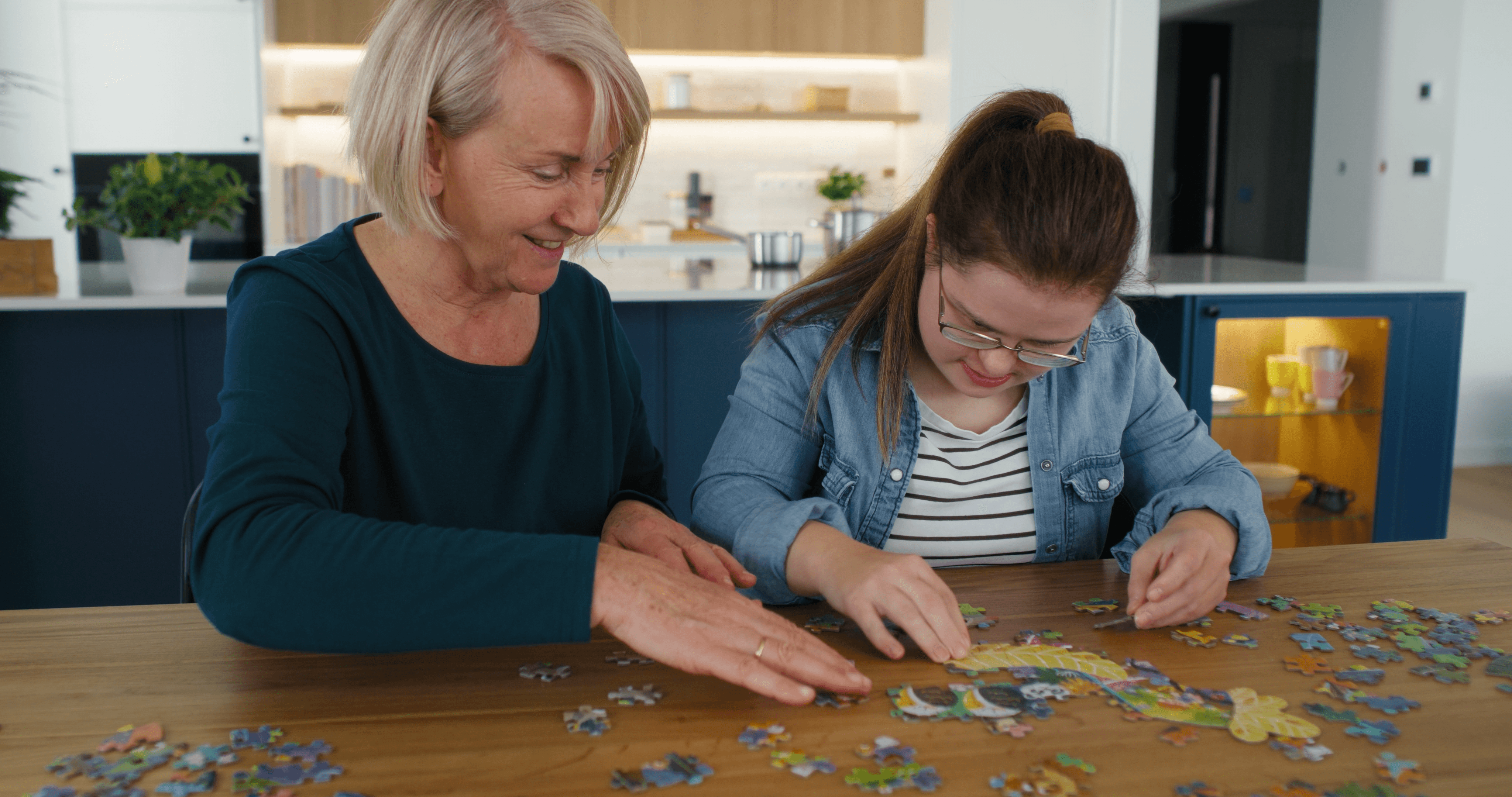 Two women doing a puzzle together.