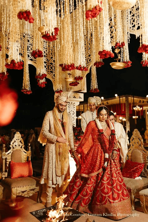 Vibrant Hindu wedding photography capturing a bustling ceremonial moment as family and friends bless the bride and groom during the wedding rituals. Ideal for showcasing traditional Indian wedding photography style.