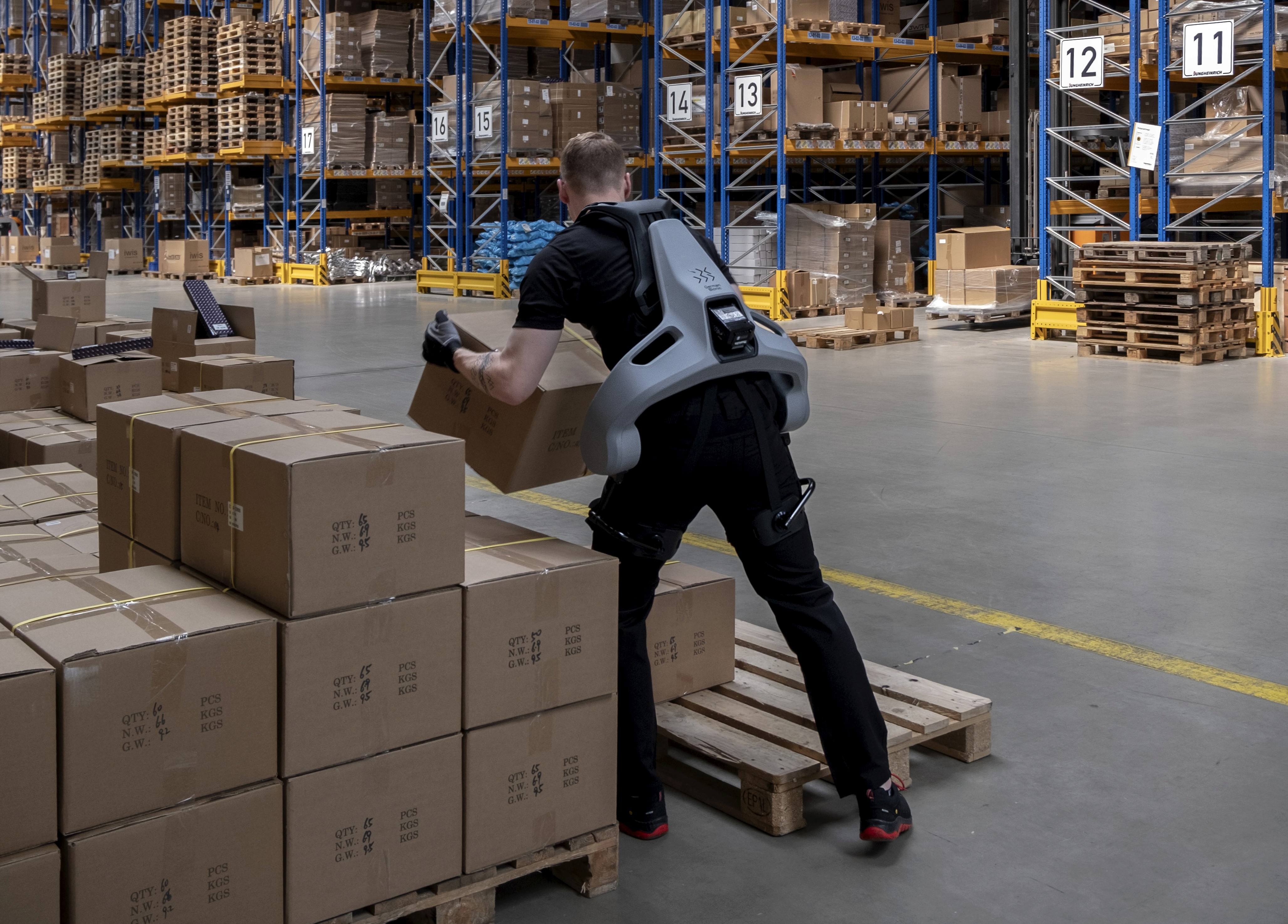 Man trägt Exoskelett im Logistik Lager zur Unterstützung beim heben