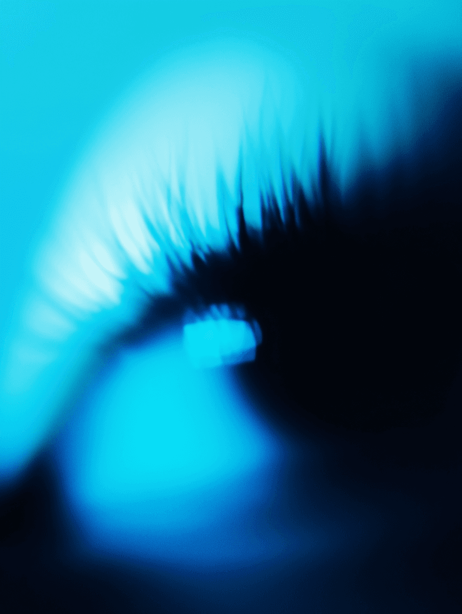 Abstract image with blurred, streaked bright blue light forming a curved wave or vortex against a dark background