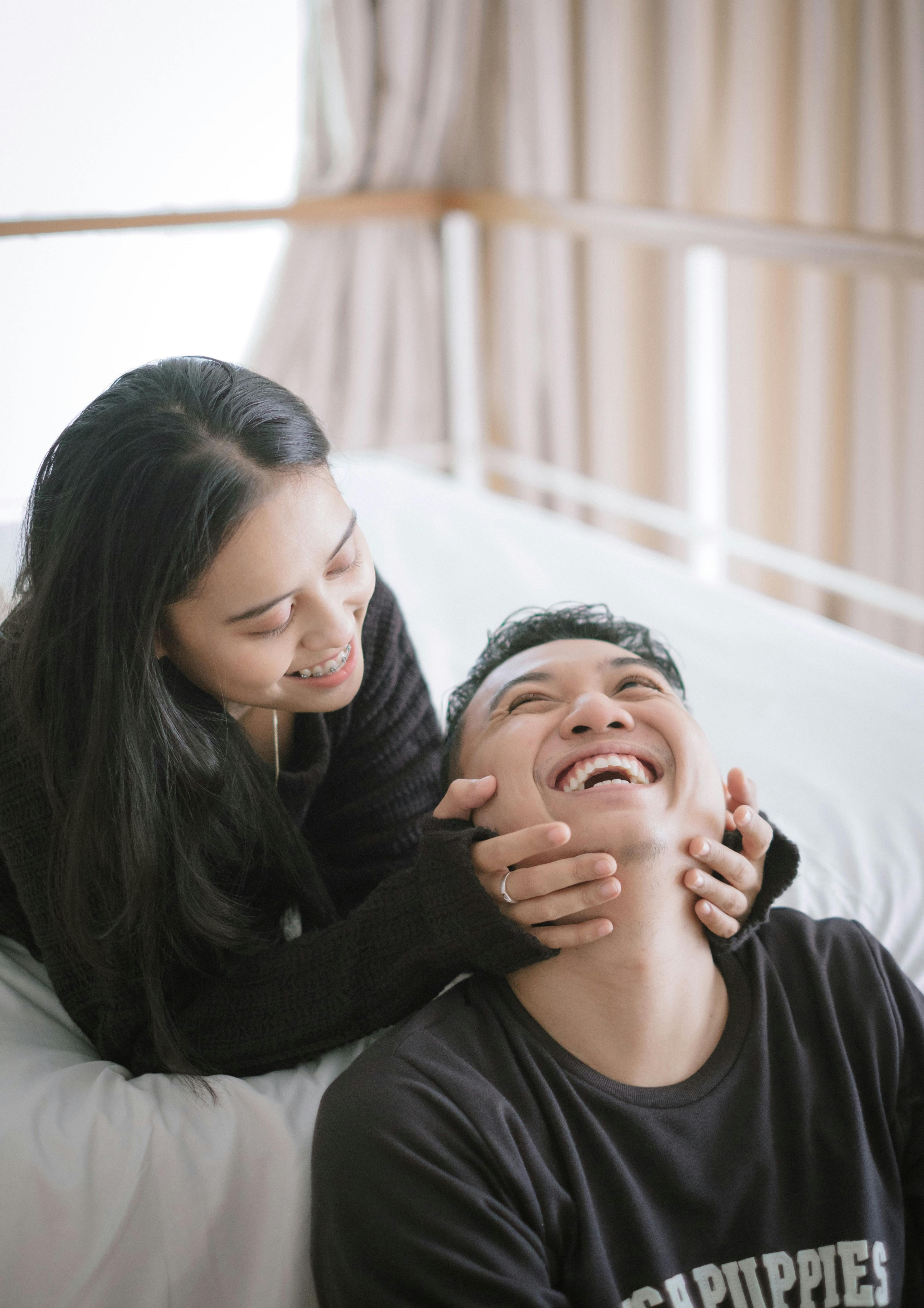 Girlfriend holding his boyfriend having a laugh