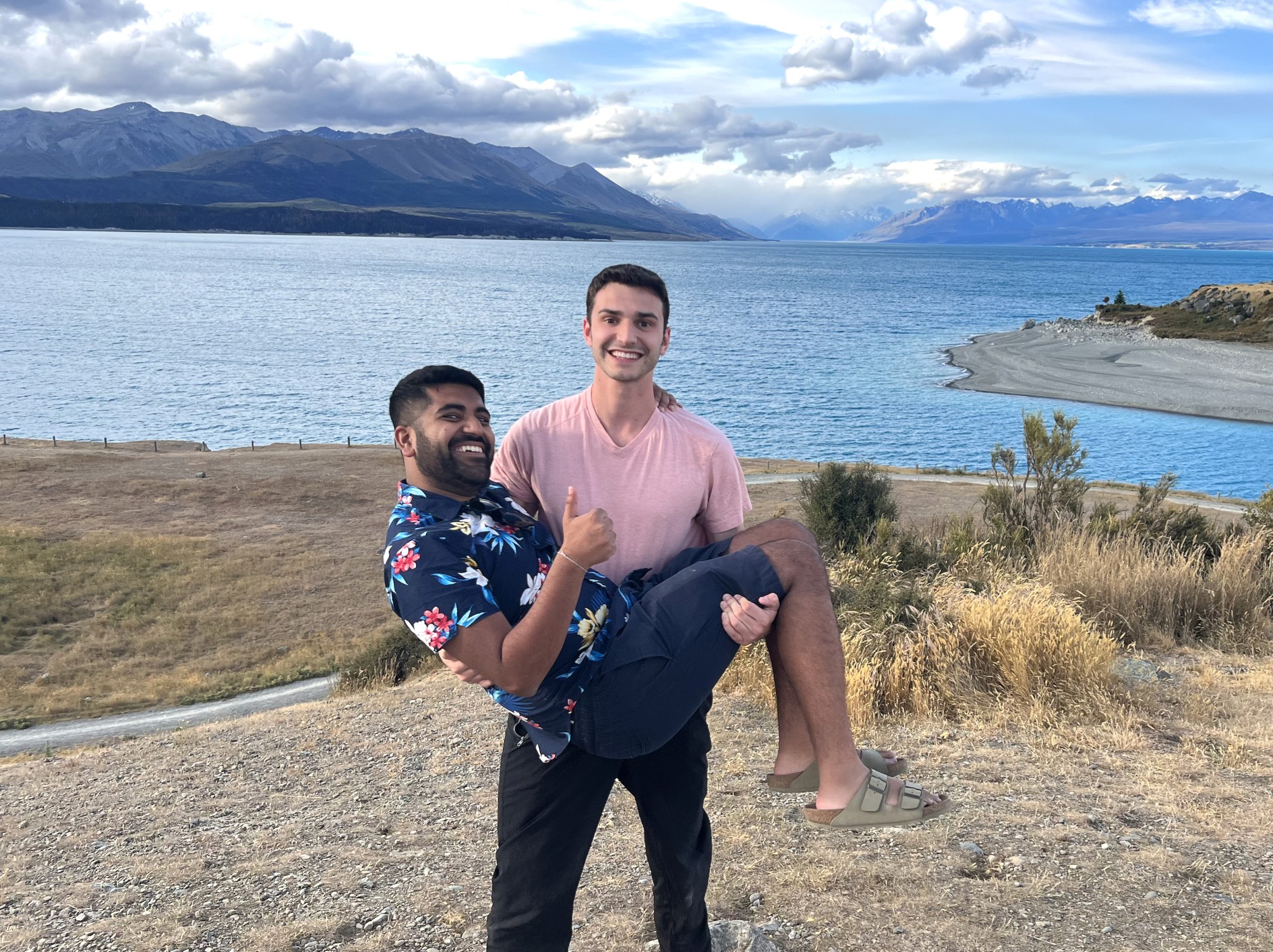 Andrew holding Malay in front of lake