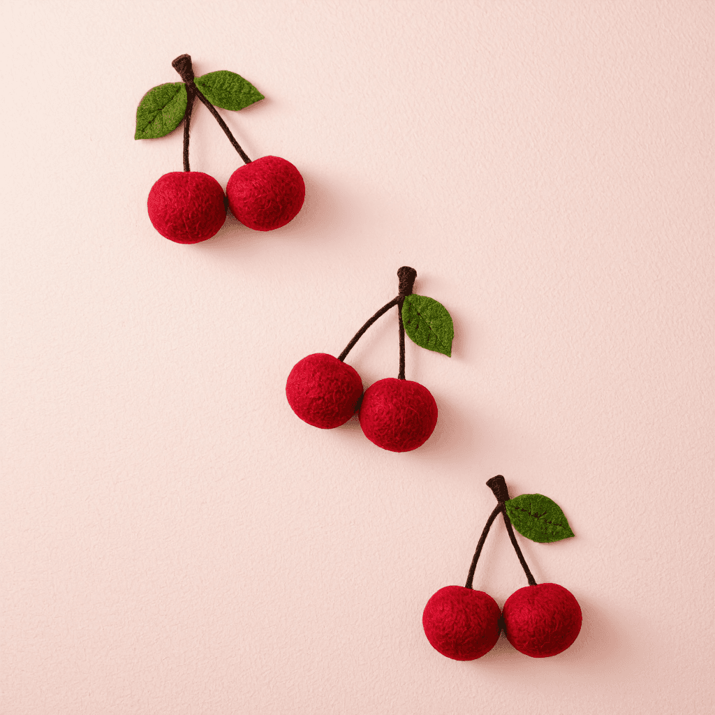 product photography of a set of cherry-shaped felt decorations