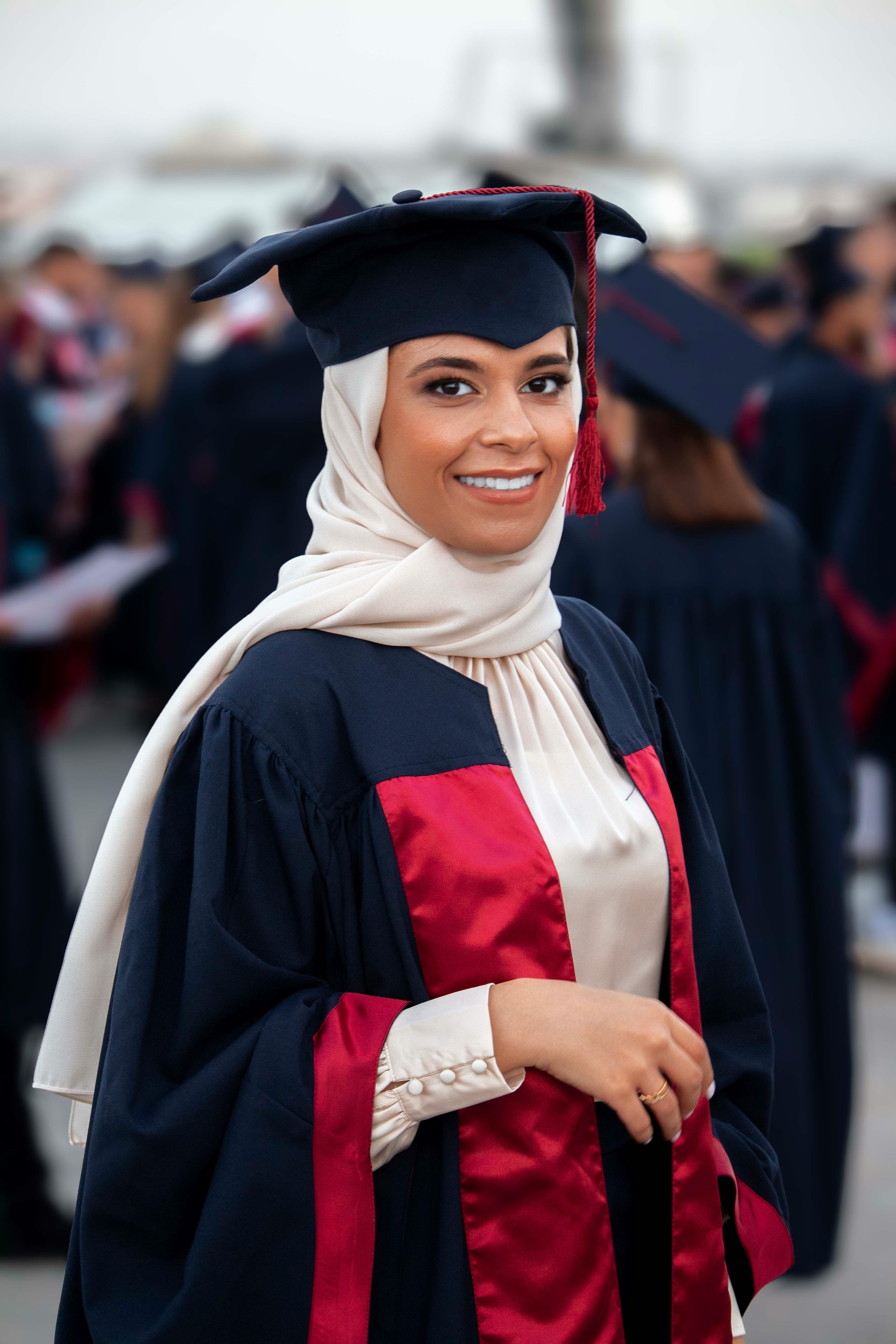 A woman in a graduation cap and gown