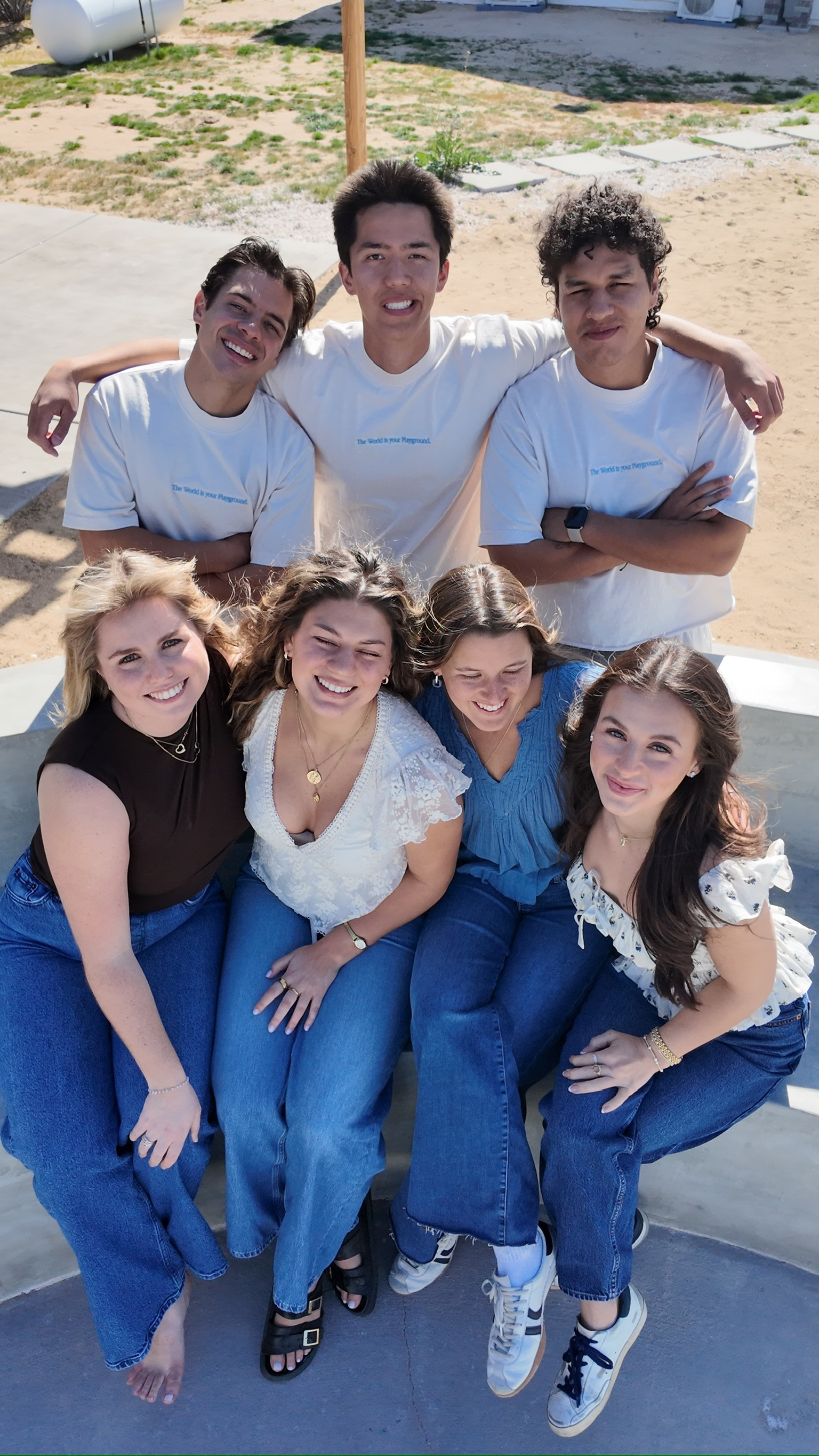 Playkit team members laughing and playing cards together during the company retreat, sitting in a cozy outdoor lounge.