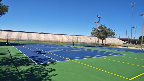 Tennis court after resurfacing, ready for competitive play
