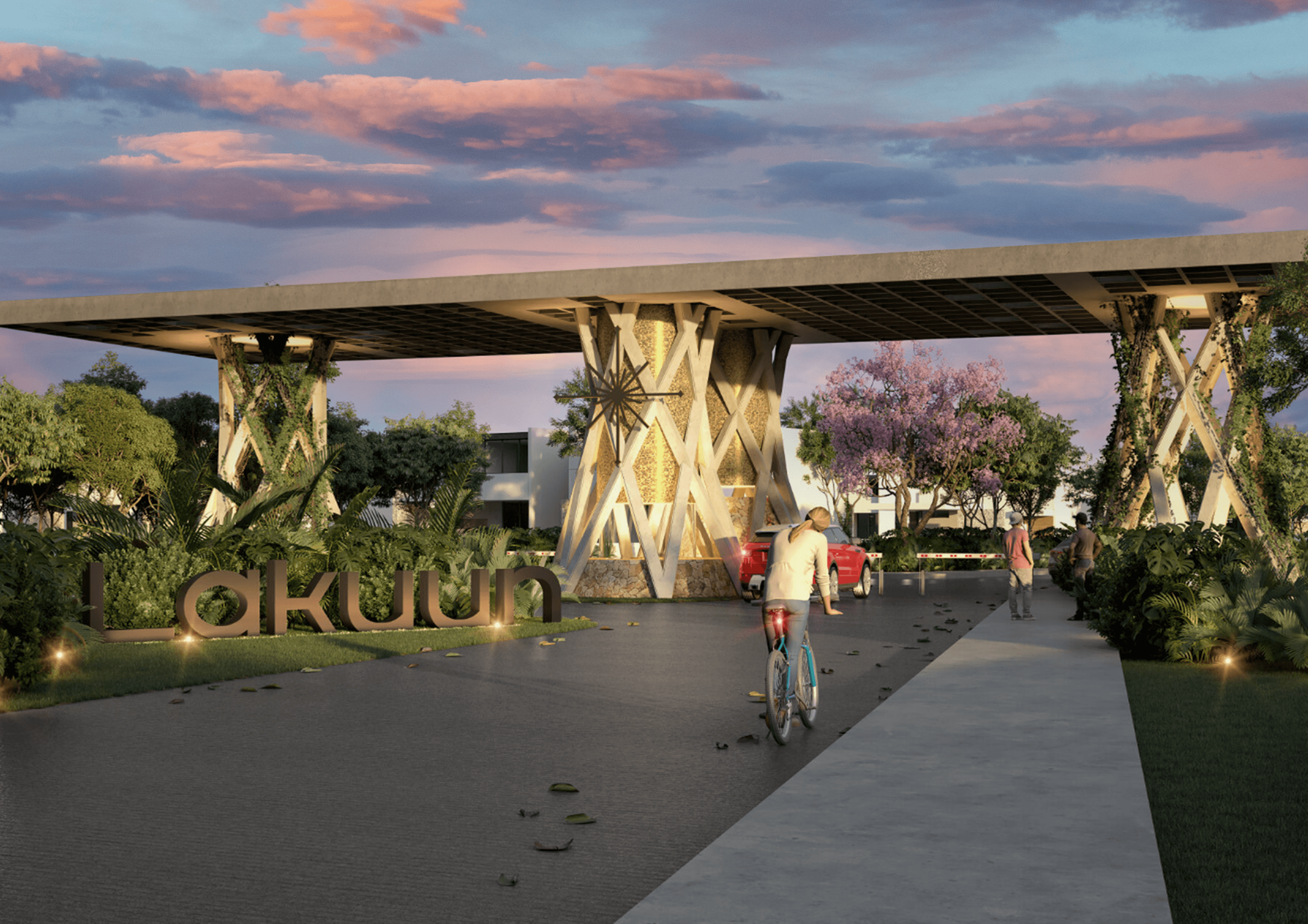 A valley with small buildings surrounded by snow-capped mountains.