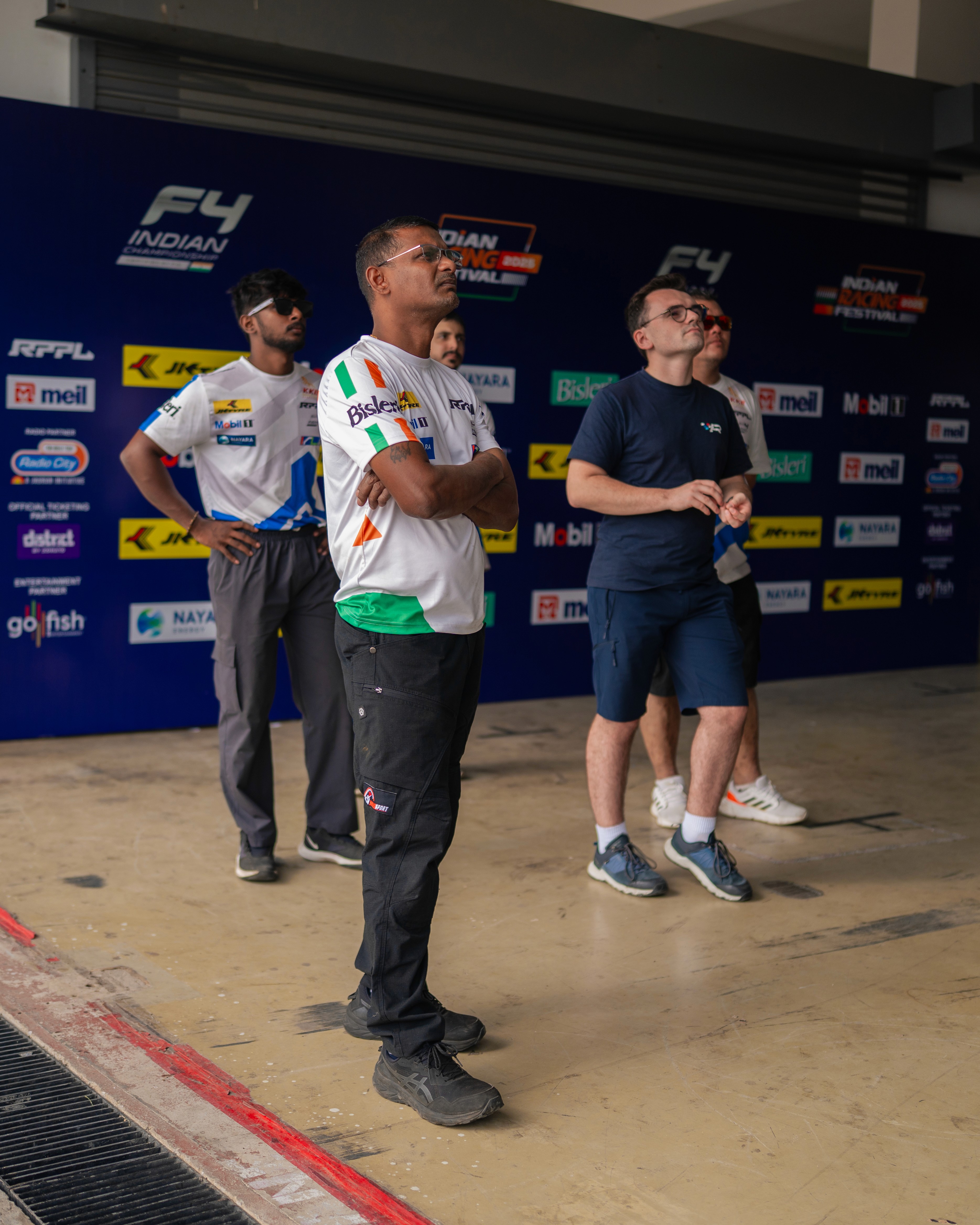 A man stading with Surfboard