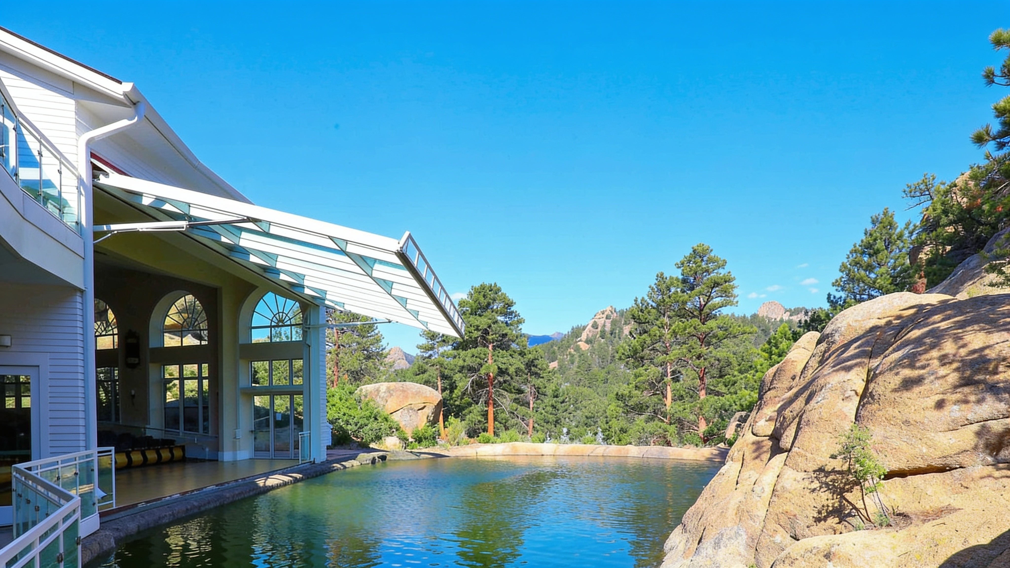 Hotel event pavilion with a glass hydraulic wall overlooking a pond