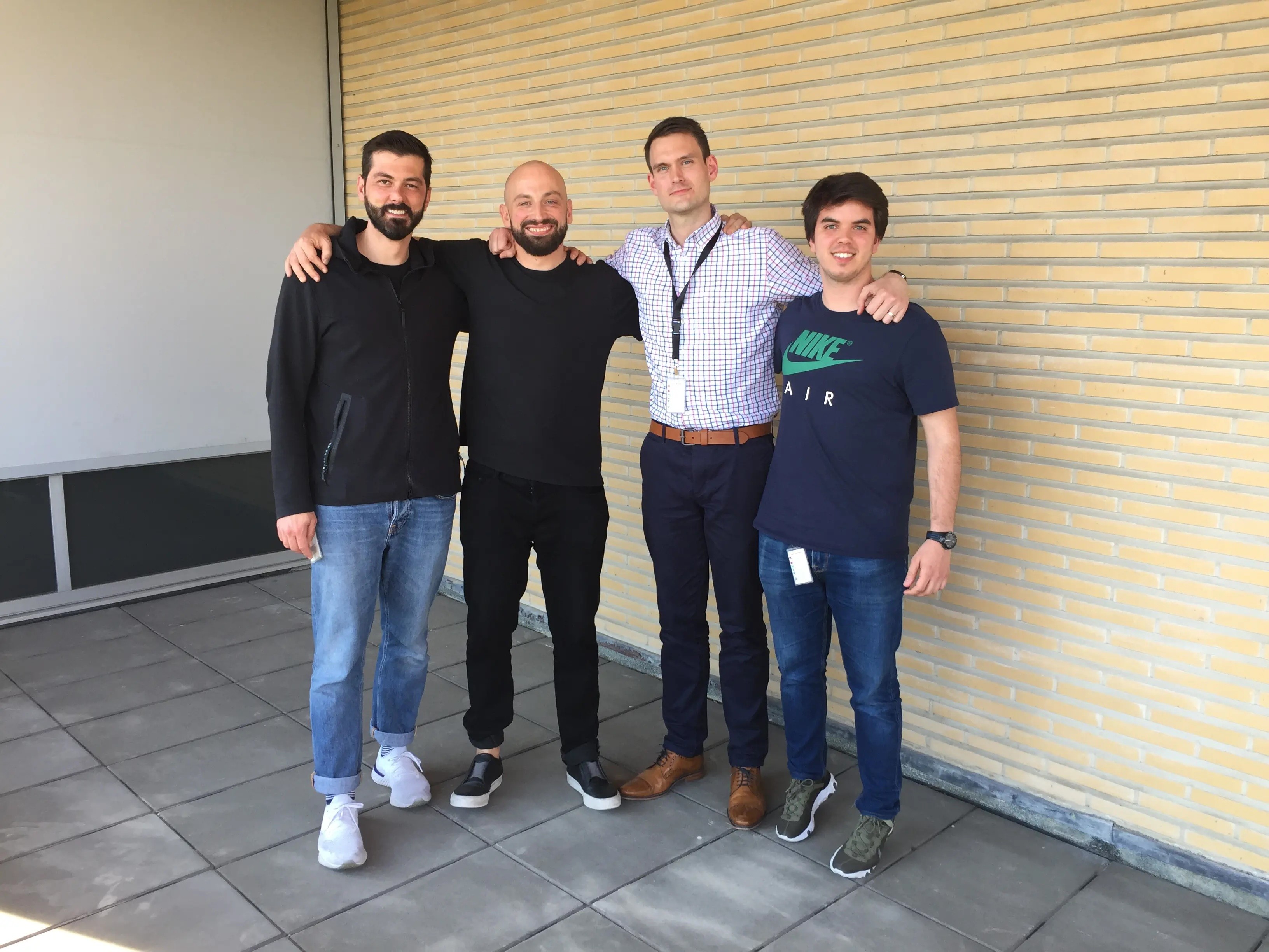 four smiling men wearing nike apparrel 