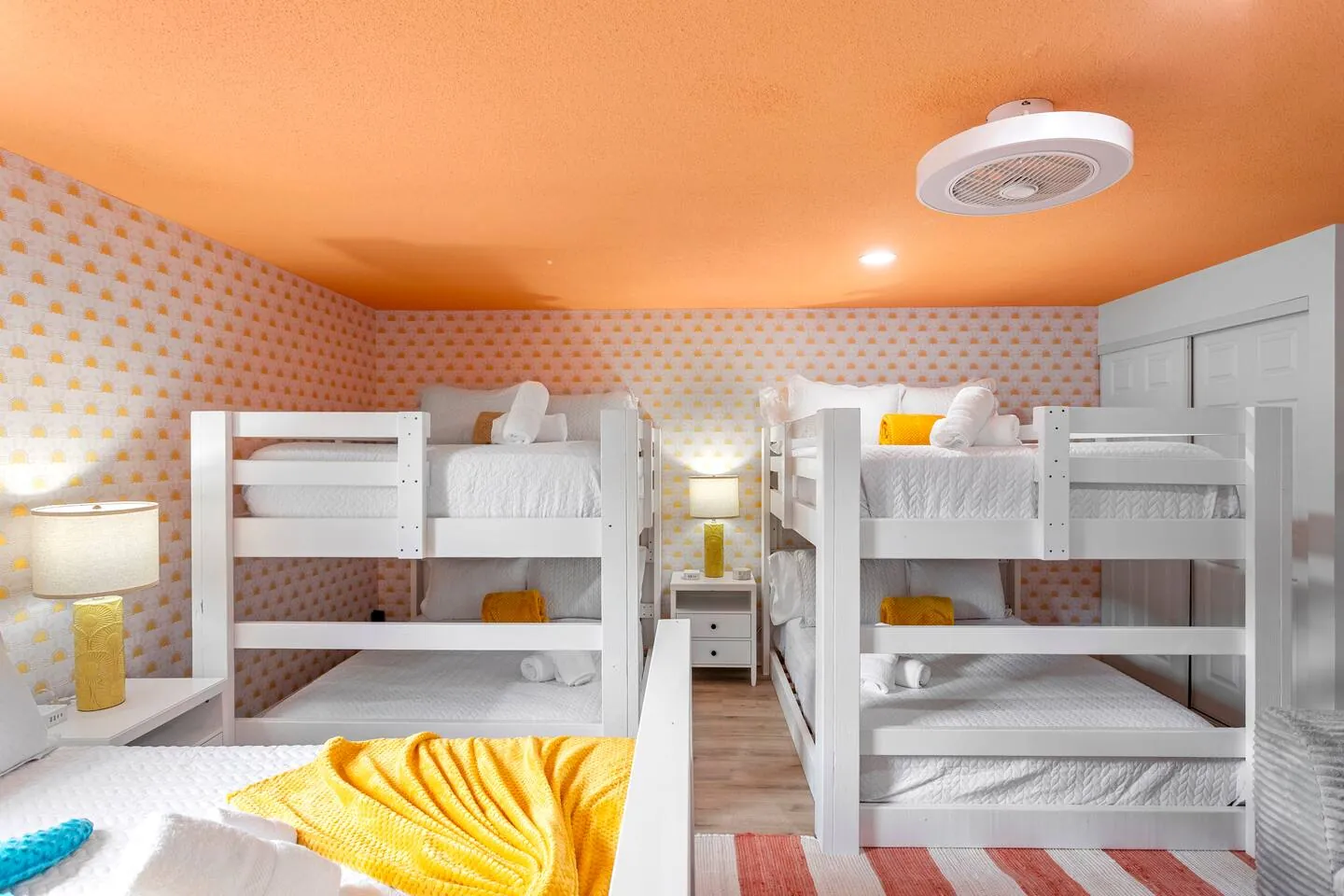 Bunk room with 2 bunk beds, orange ceiling and patterned wallpaper at Private Backyard Resort, Bradenton, Florida