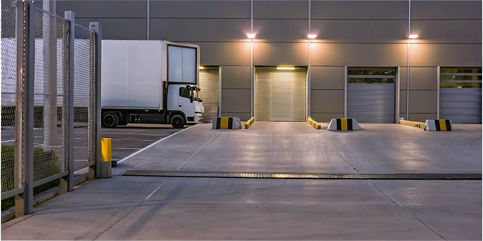 Loading dock entrance with delivery truck and security checkpoint at a modern commercial building