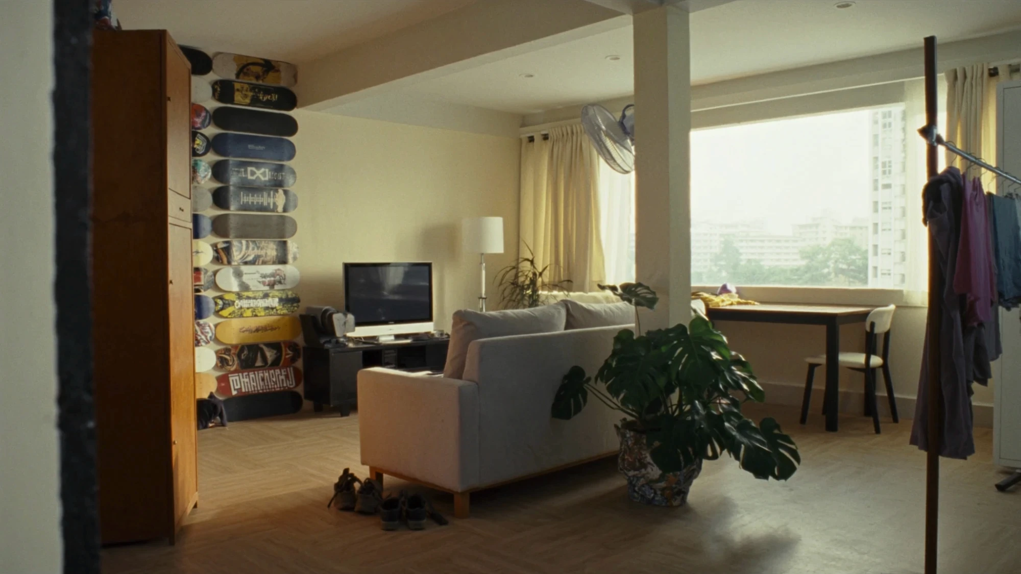 Living room location reference with a wall of old skateboard decks
