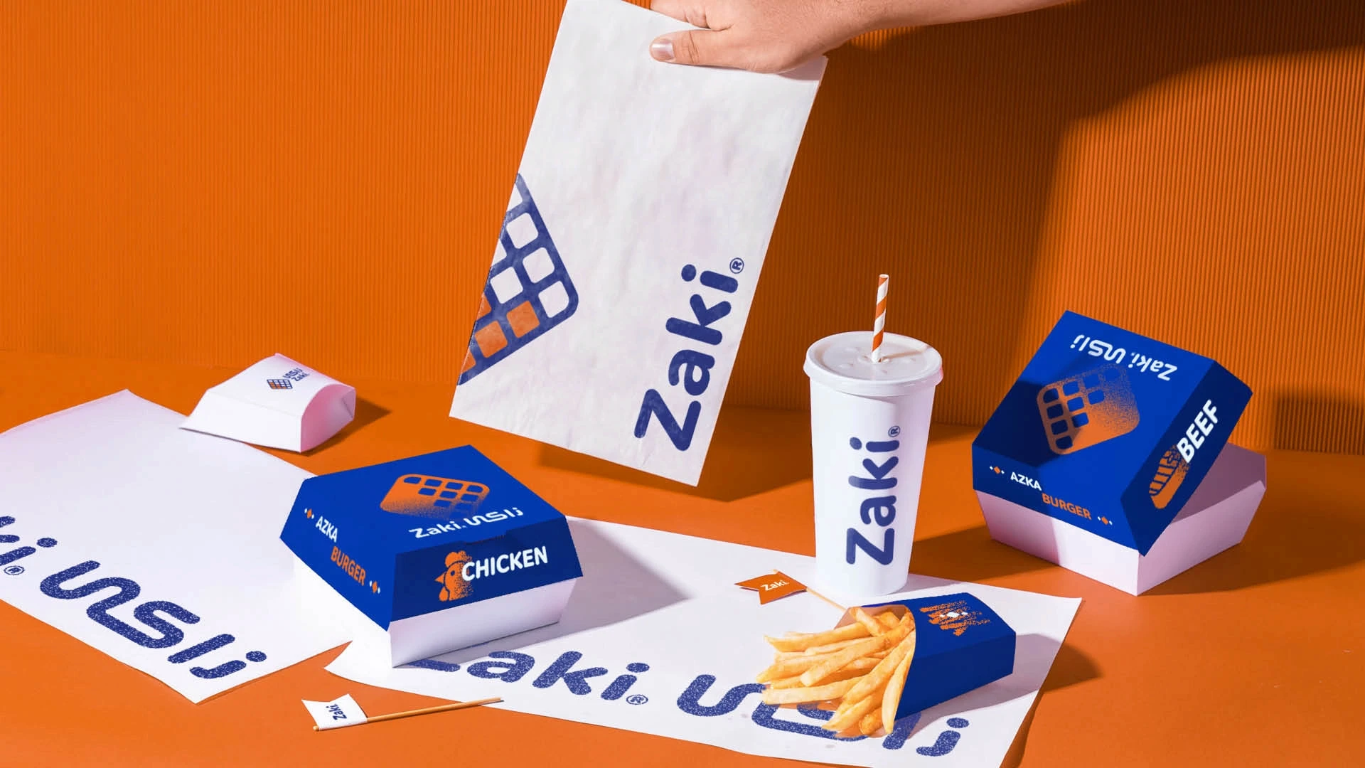 Streetside billboard with flyposters of the Batch.Works brand and illustrations
