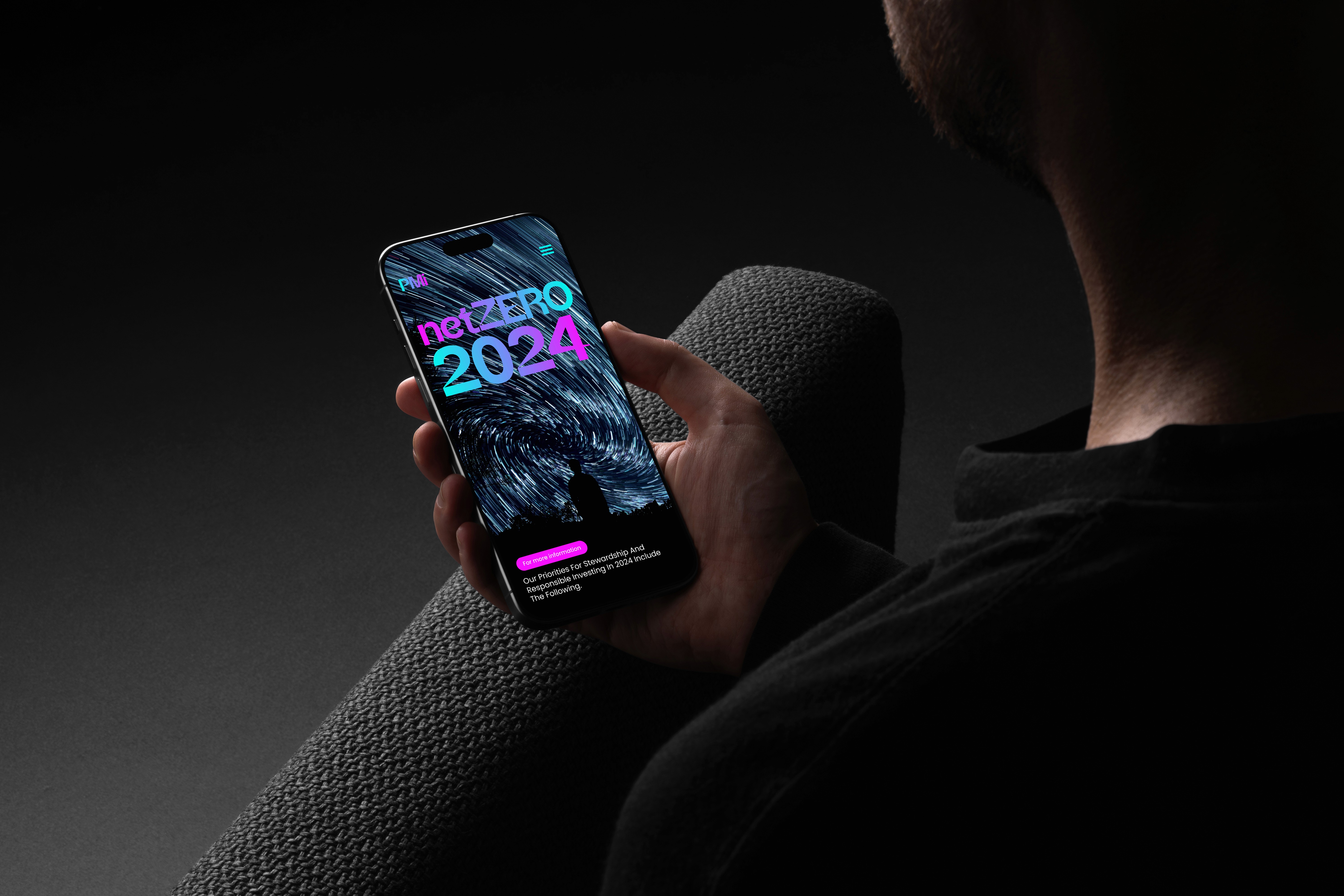 Man holing iPad showcasing Premier Miton web design concept screen.