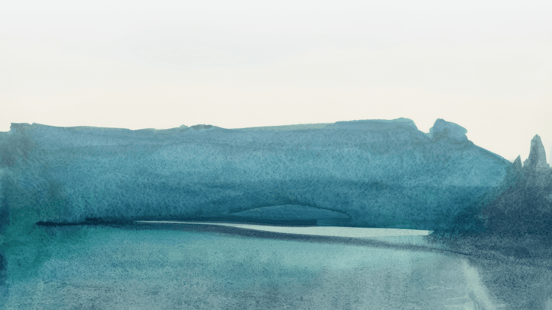 Misty blue landscape with water and distant hills
