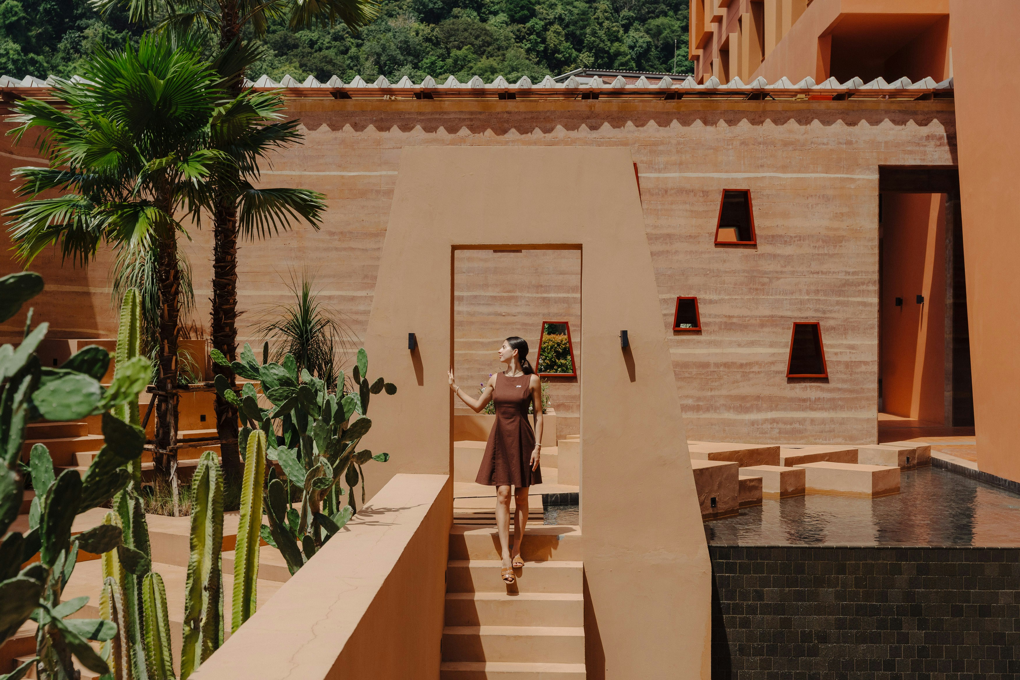 Woman walking down stairs in a modern resort