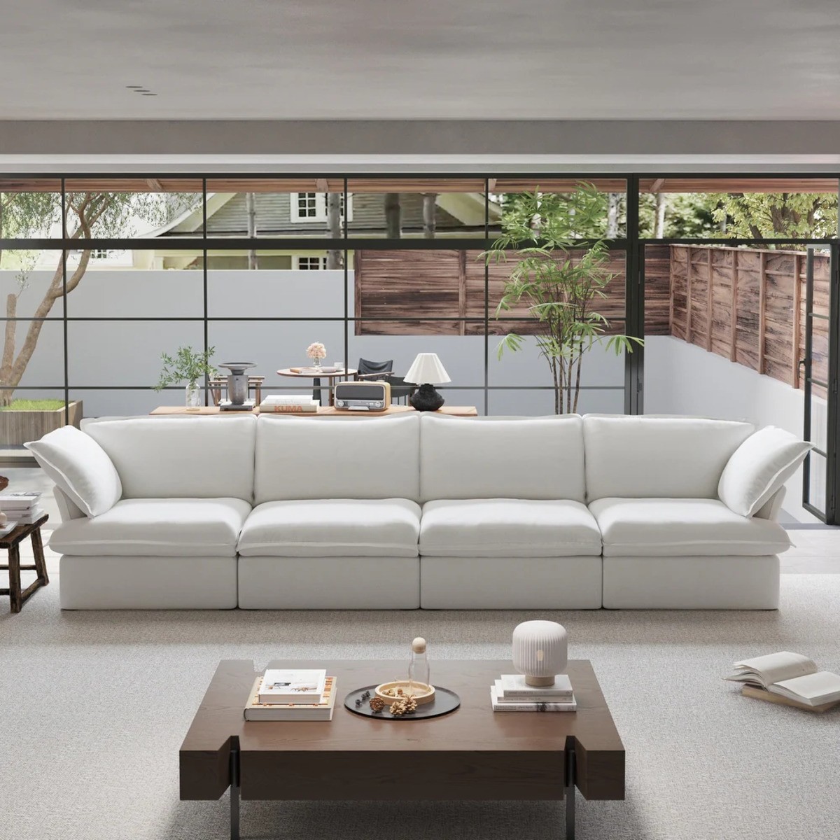 Minimalist Down-Filled Comfy Cloud Sectional in a living room with large windows, gray carpet, & wood coffee table