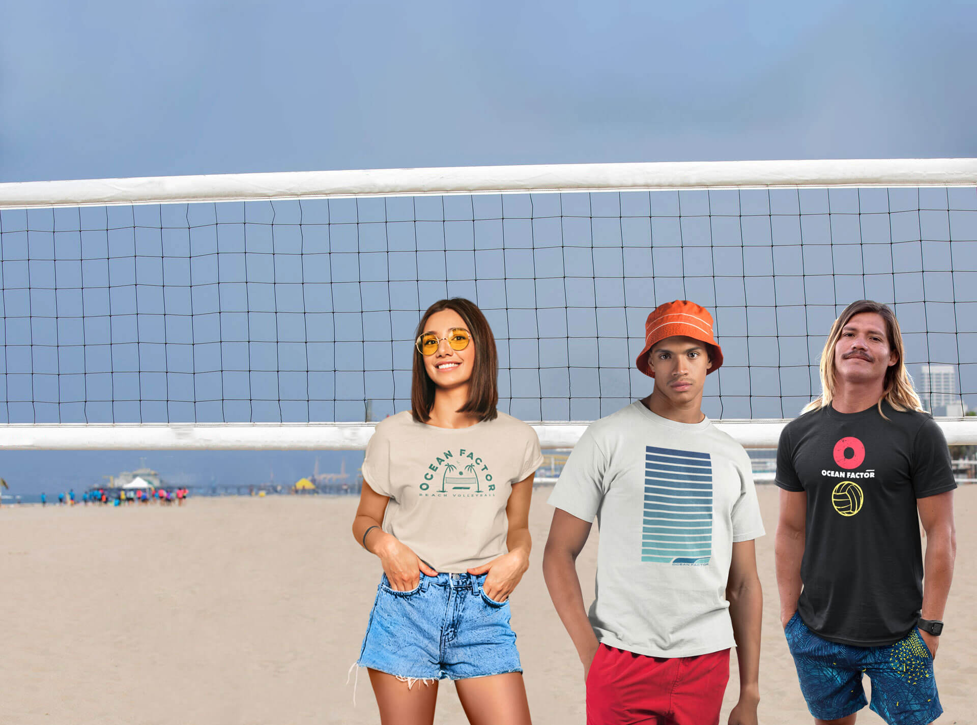 Two male models and one female model modeling beach volleyball tshirts on the beach infront a beach volleyball net