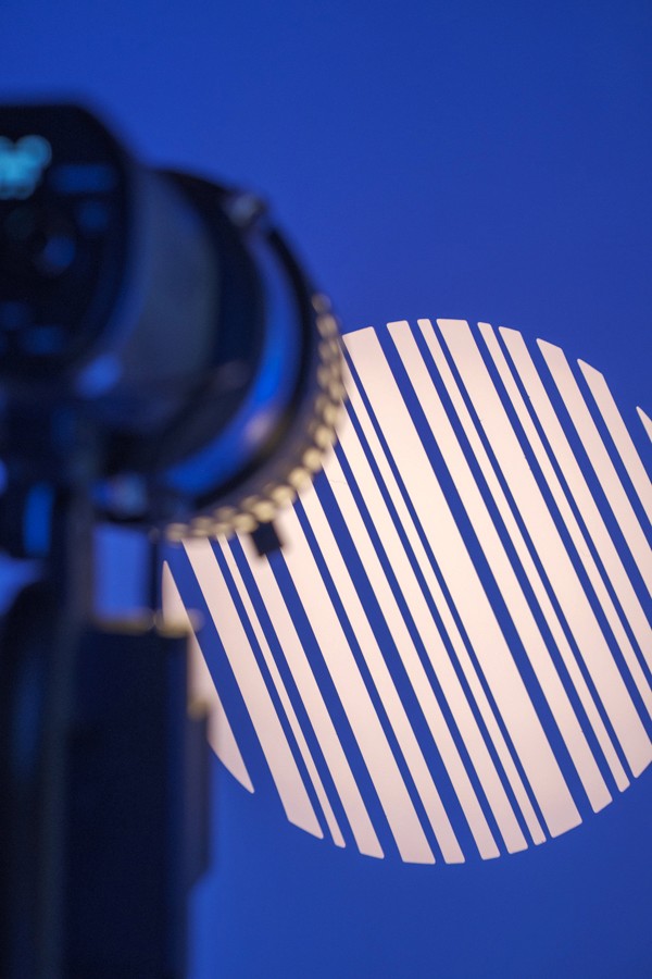 Optical spotlight projecting a striped circle on a blue background