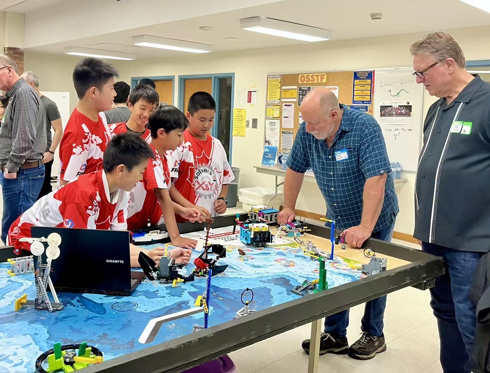 Technicians from FLL team Solvers of X & Y showcases their Lego robot to Alumni of Dr. G.W. Williams SS
