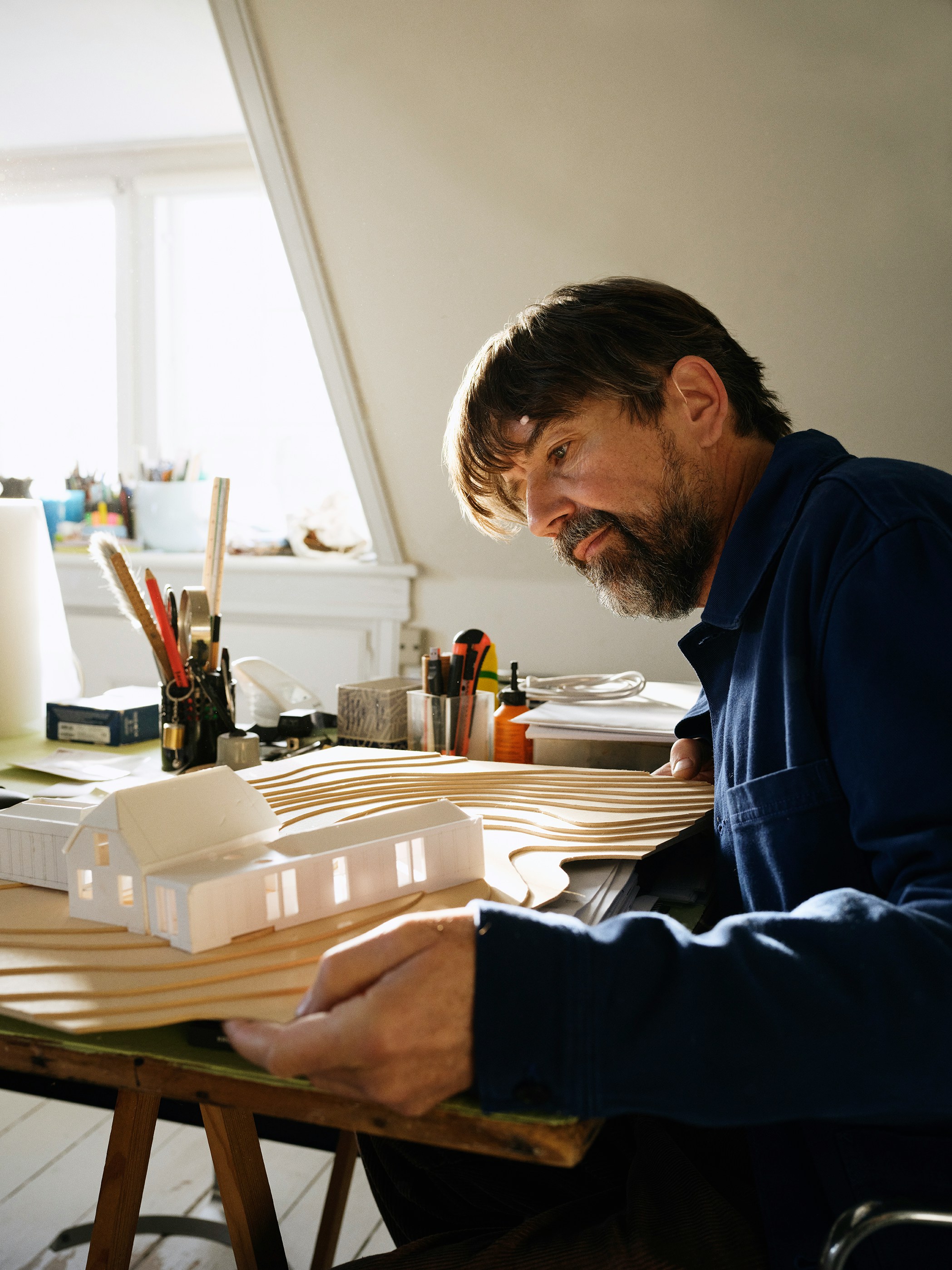Man working on architectural model at desk