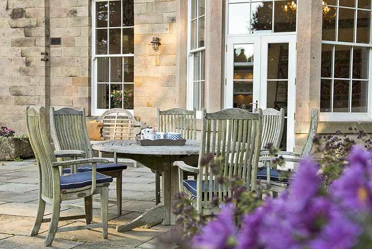 Hartingtons Heritage Tours hotel, Darley House, garden with wooden chairs and table