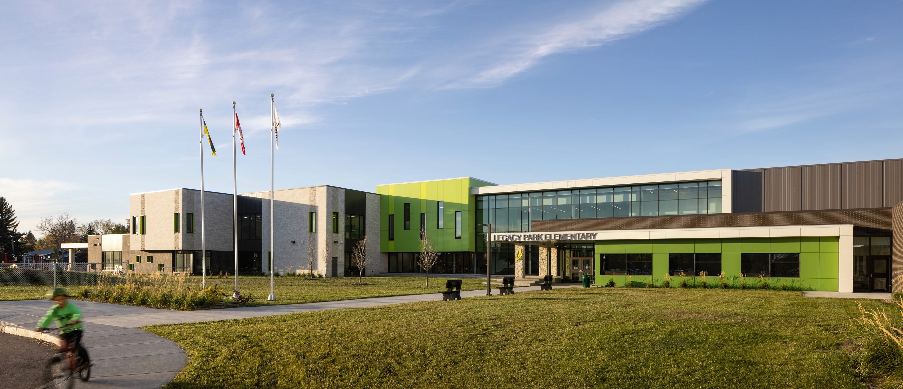 Expansive glass panels dominate the facade, creating a seamless connection between the interior and exterior.