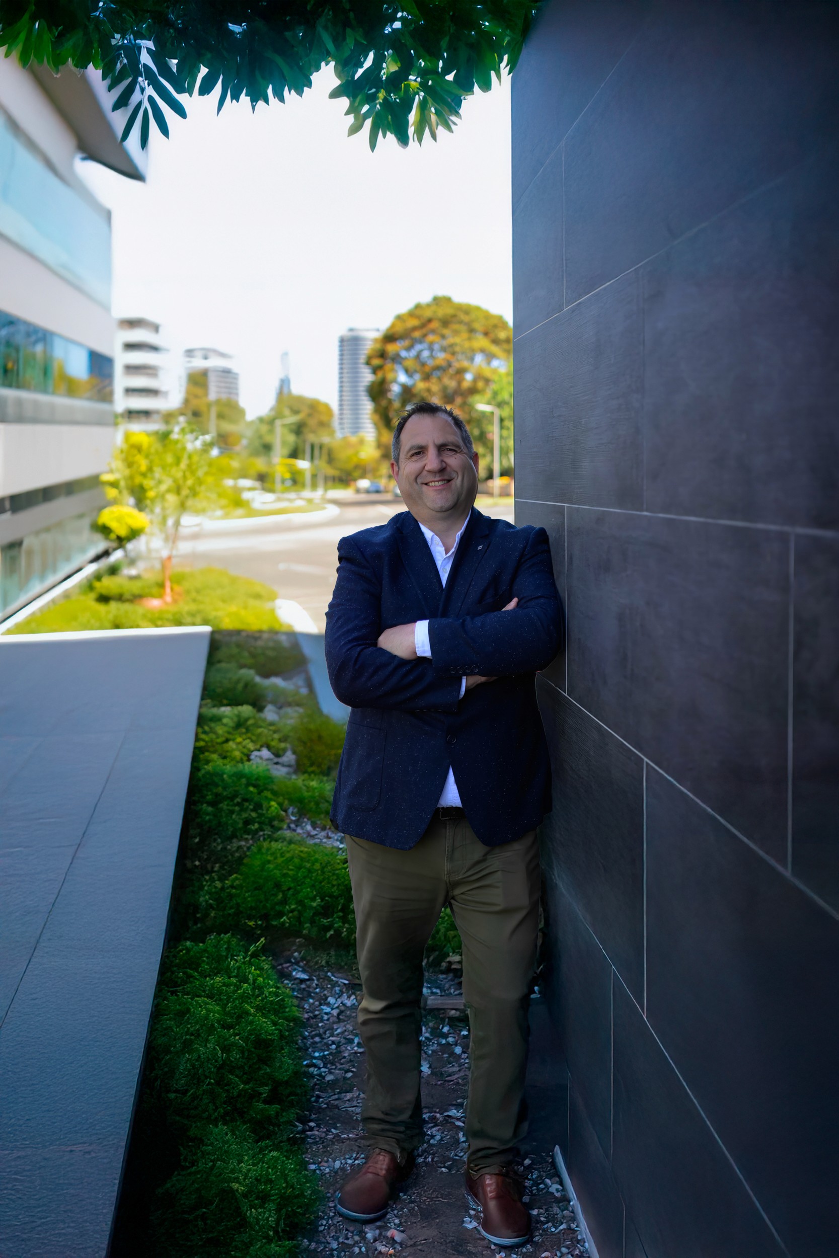 man wearing inner dress shirt with black blazer standing outside at daytime
