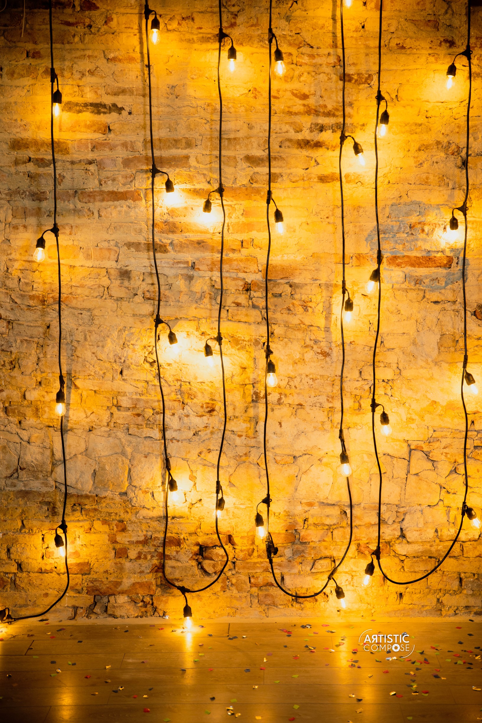 Three models standing in a wheat field, wearing beige suits.