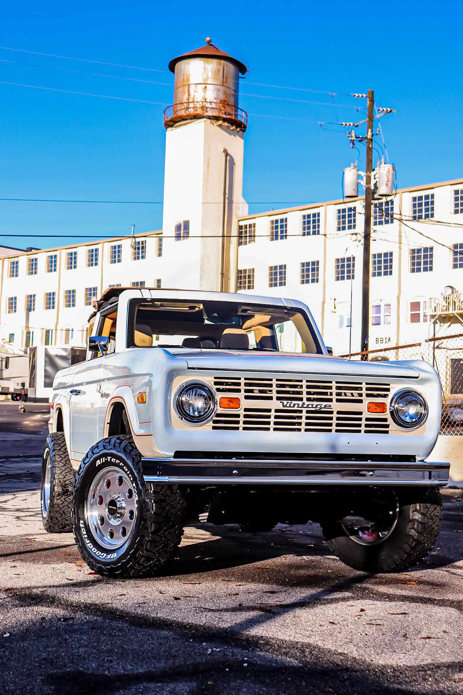 Man with camera near lake and mountains