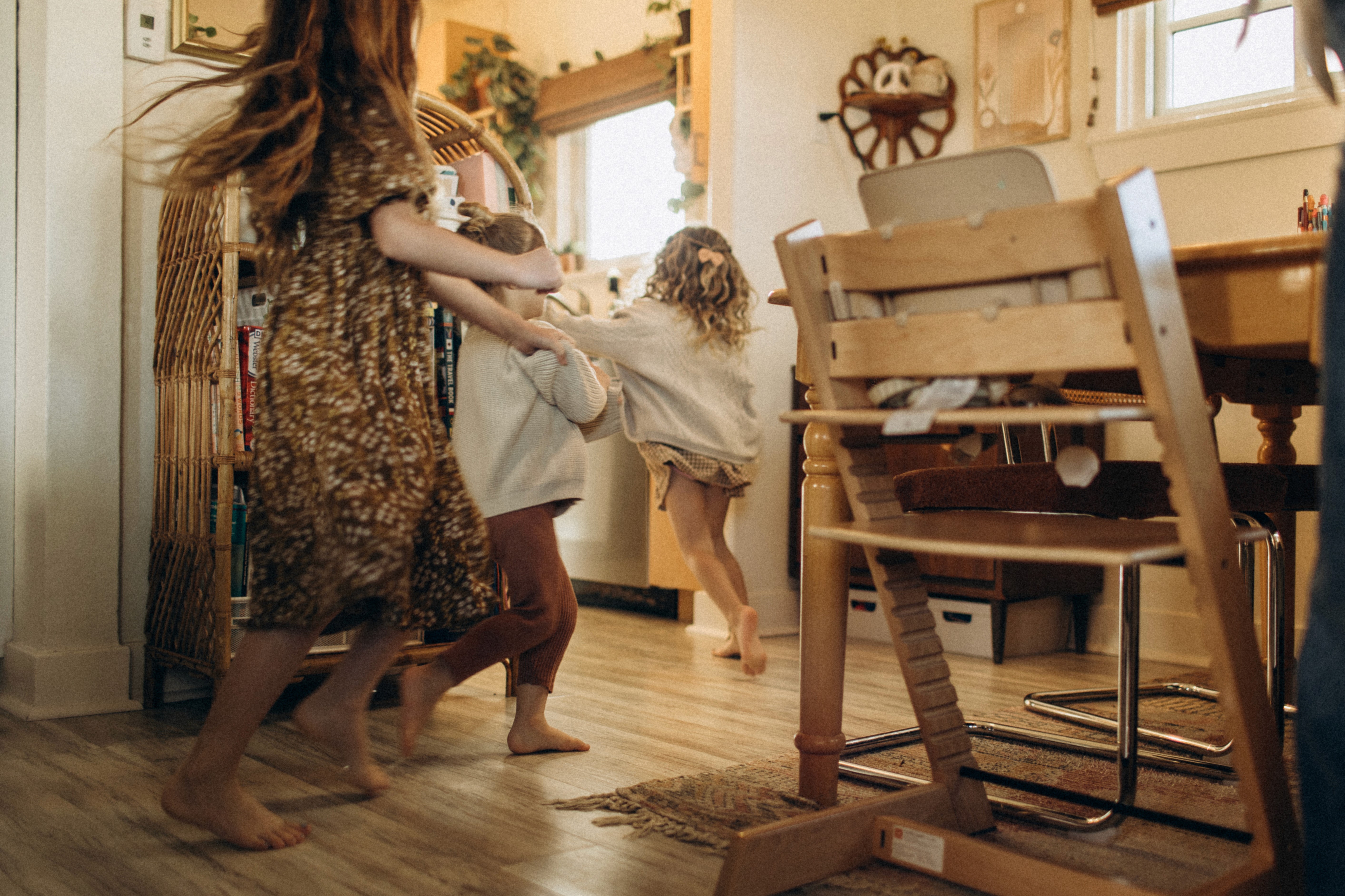 Family moving through their home, documenting natural daily moments and connection.