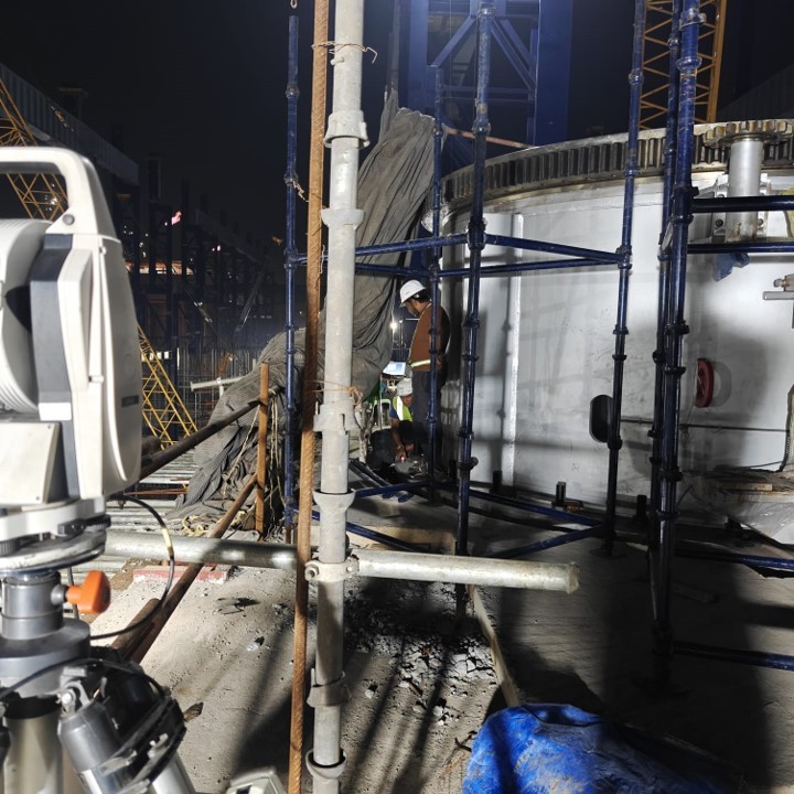 Blurry cityscape with tall buildings at night.
