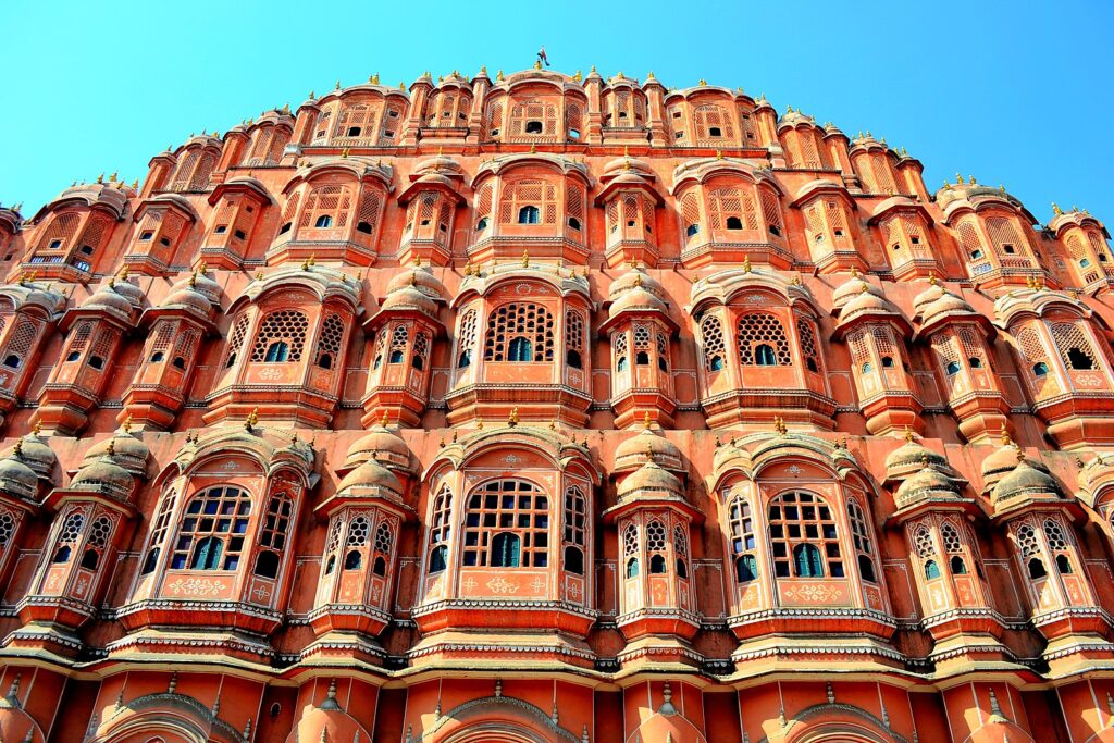The honeycombed structure of Hawa Mahal with 5 storeys and 953 jharokas or small windows, each opening out to the busy street below