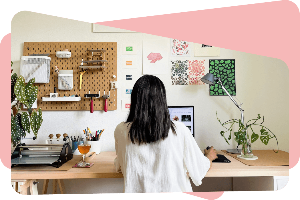 Photo of Aditi Vijay working at her desk.