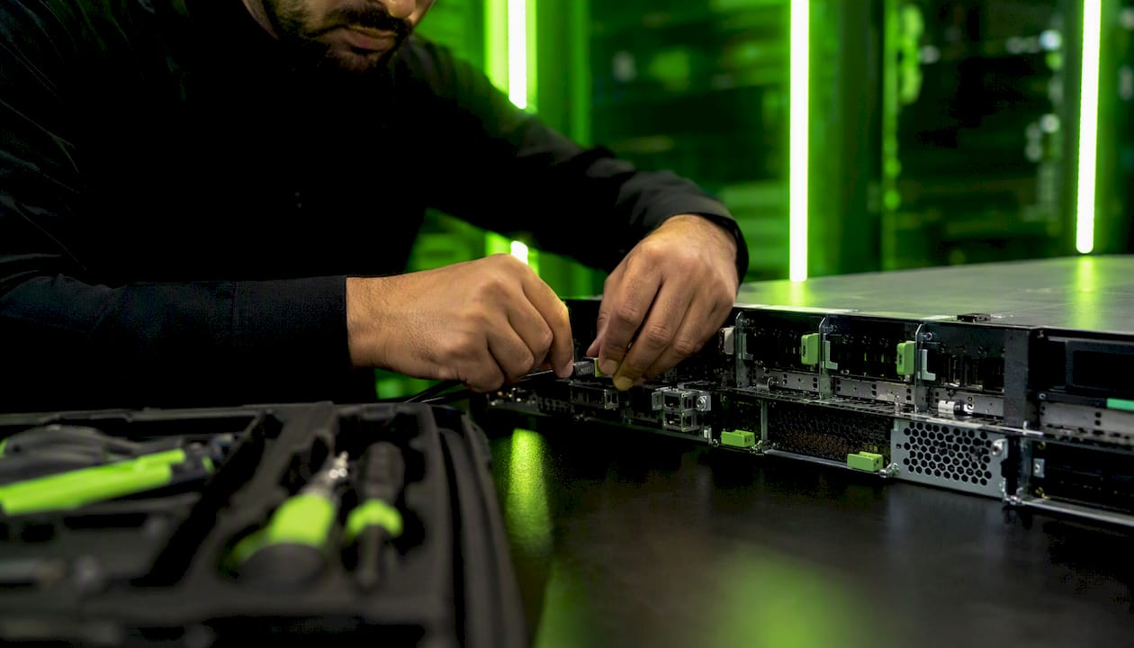 Hands maintaining servers in UAE tech workspace