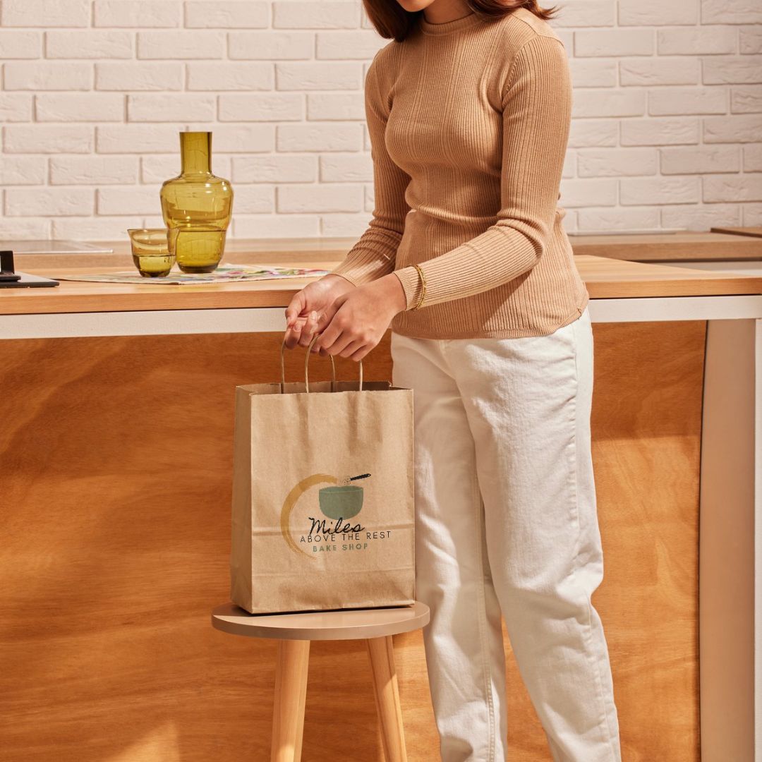 Woman picking up bakery to go bag